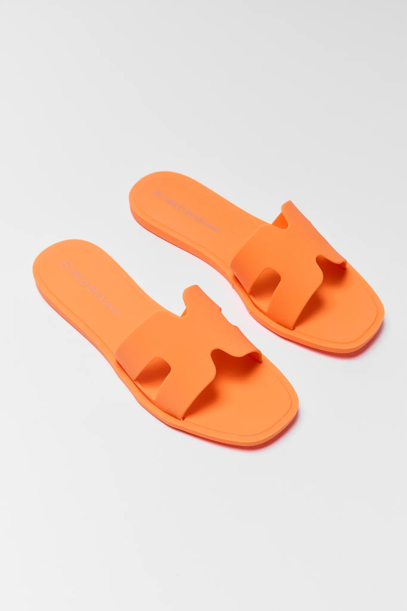 Pair of orange slides on a light gray background
