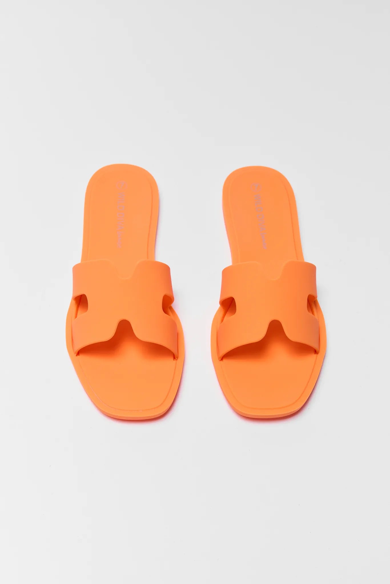Pair of orange slides on a light gray background
