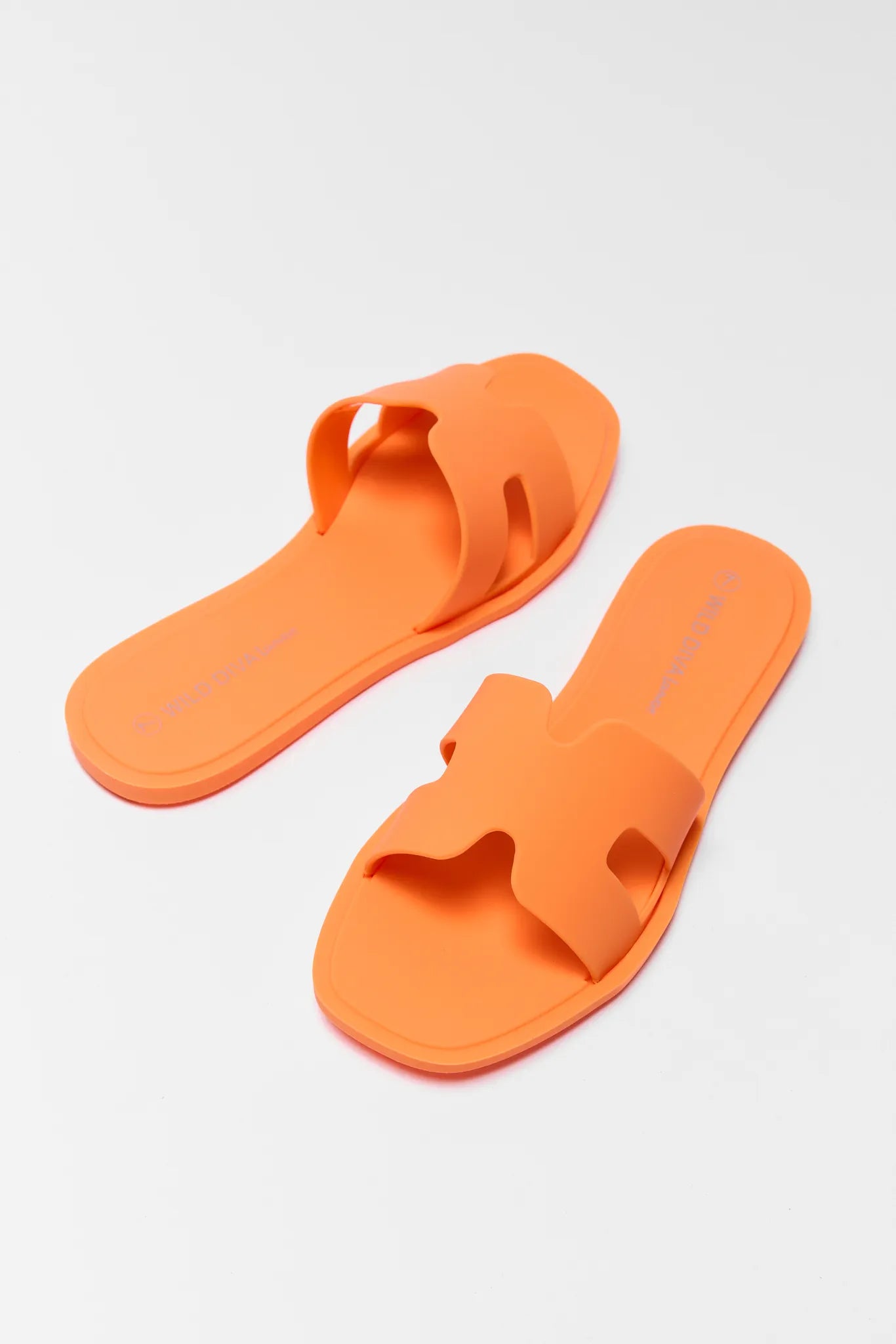 Orange sandals on a light gray background