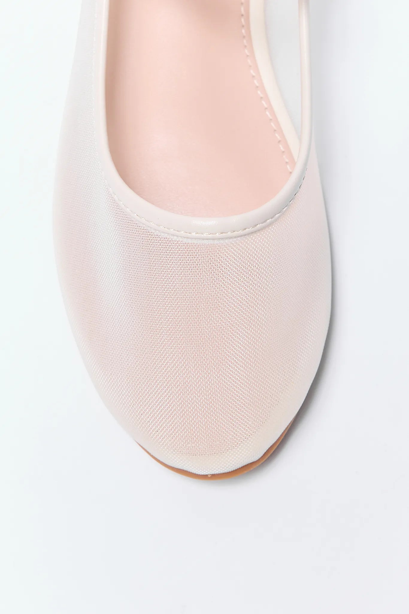 Close-up of a light Jane Flats shoe on a white background