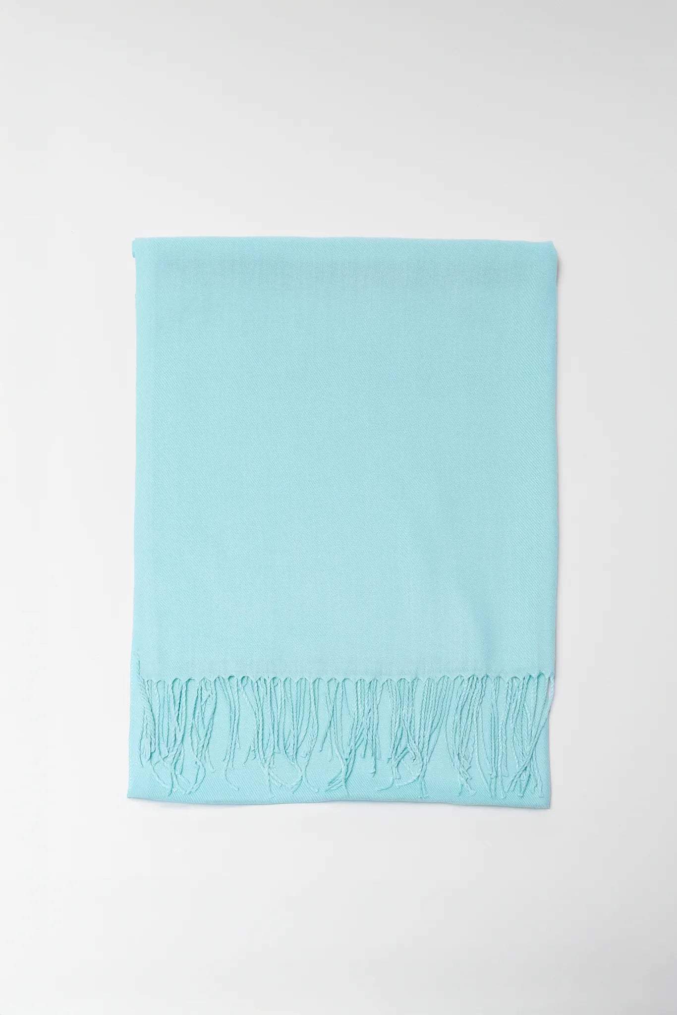 Light blue scarf with fringe on a white background