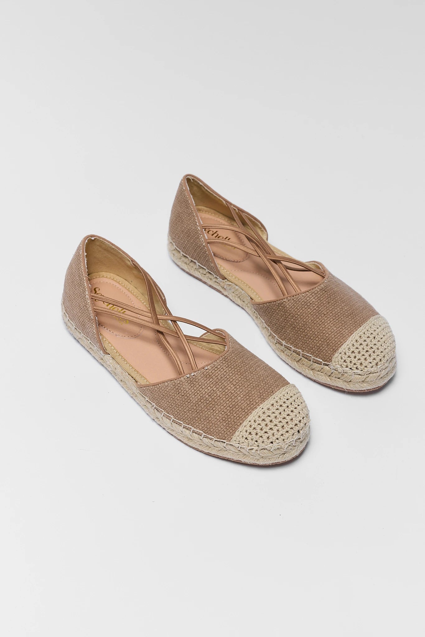 Pair of brown espadrilles on a light gray background two
