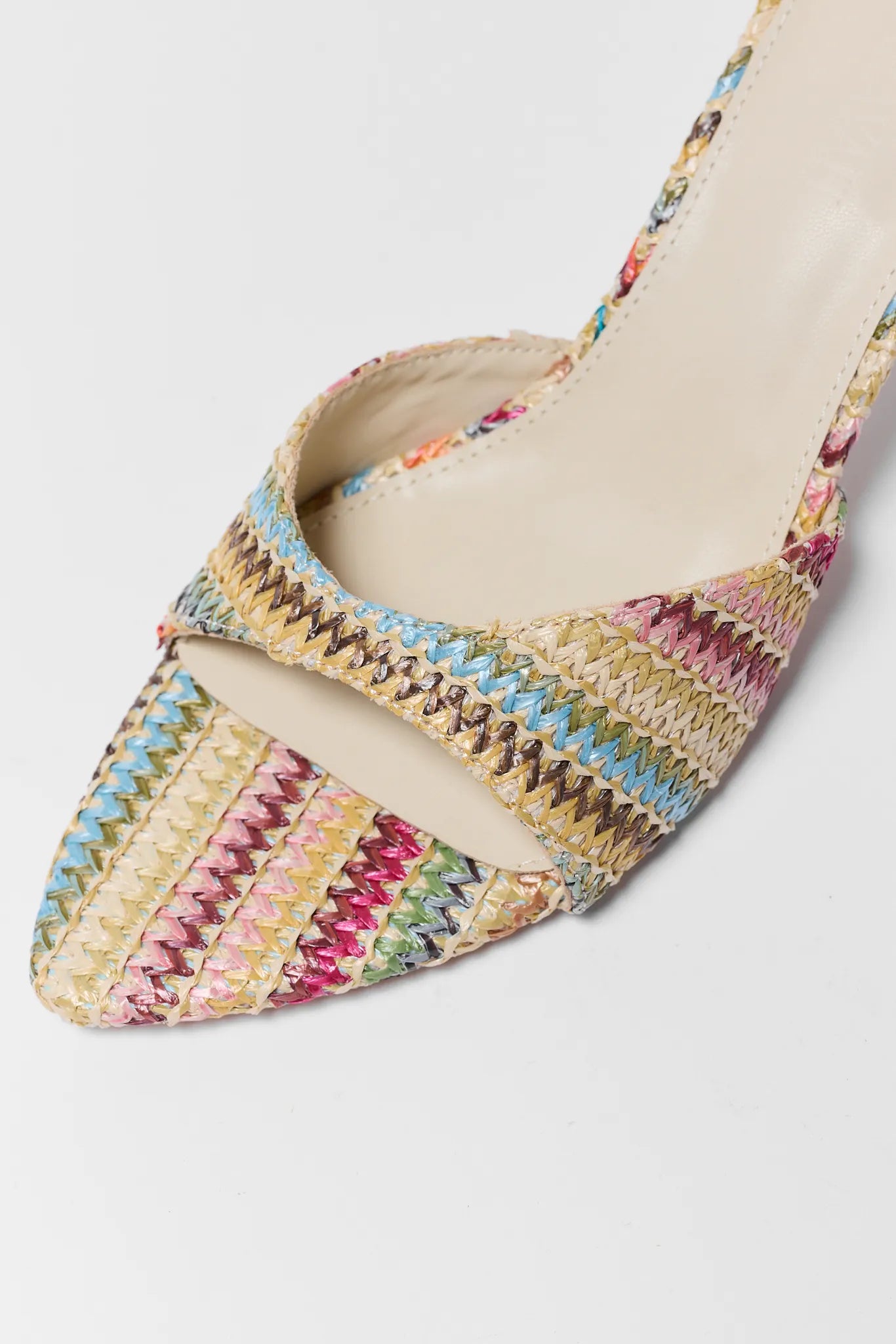 Multicolored woven shoe on a light gray background