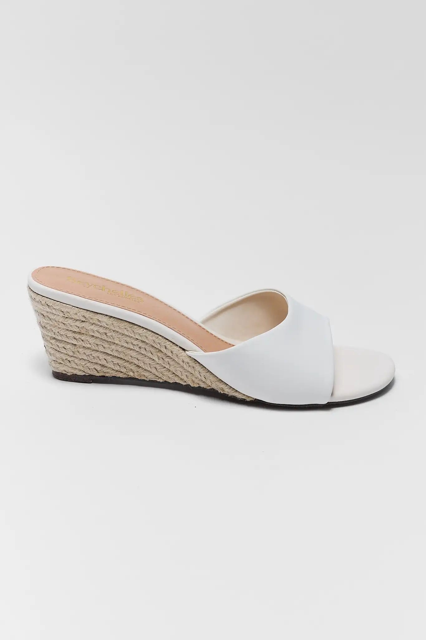 White wedge sandal with espadrille sole on a white background one