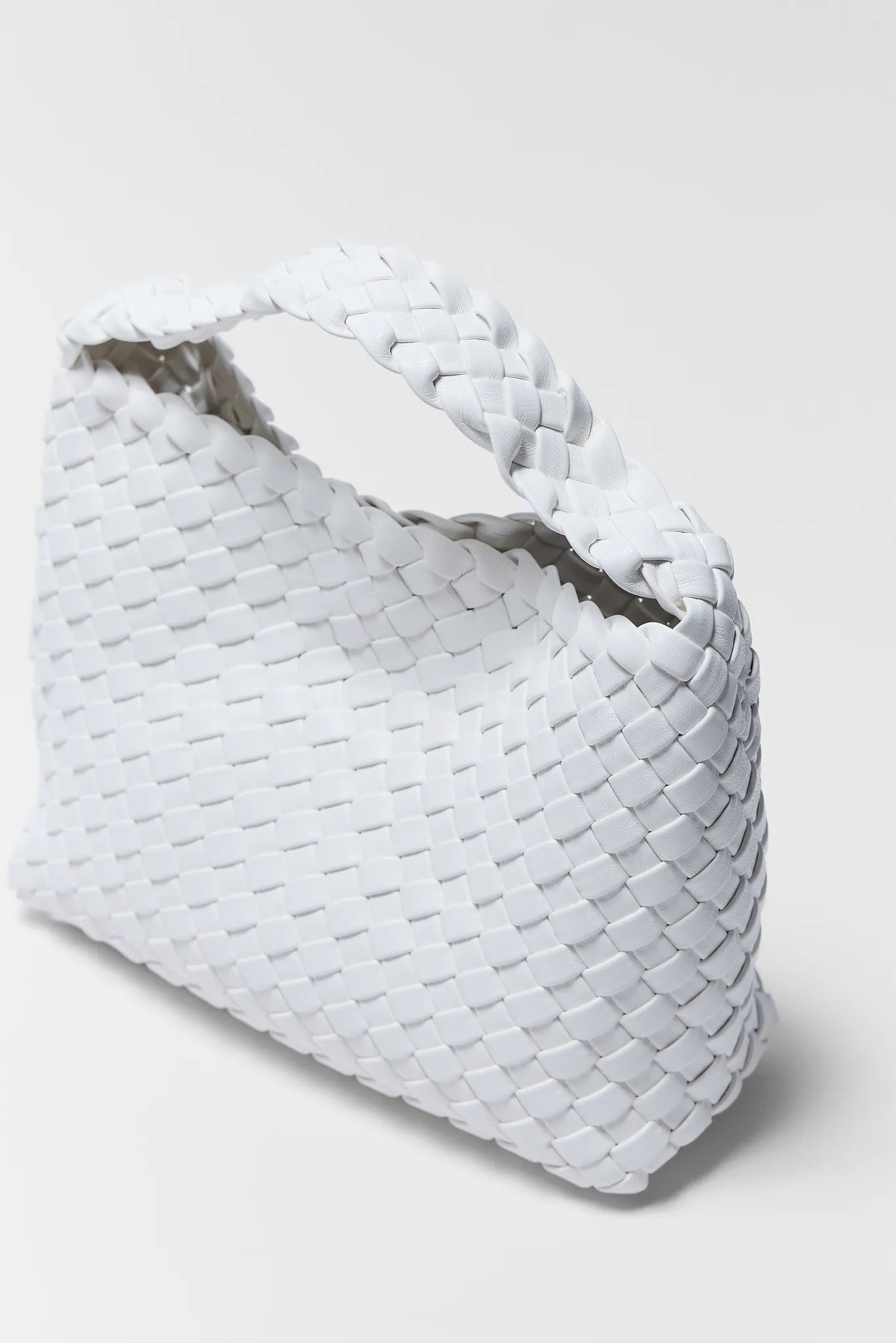 White woven basket on a light gray background