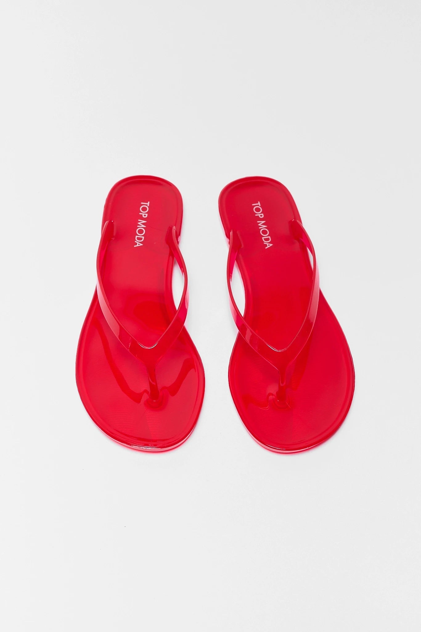 Red sandals on a light gray background two