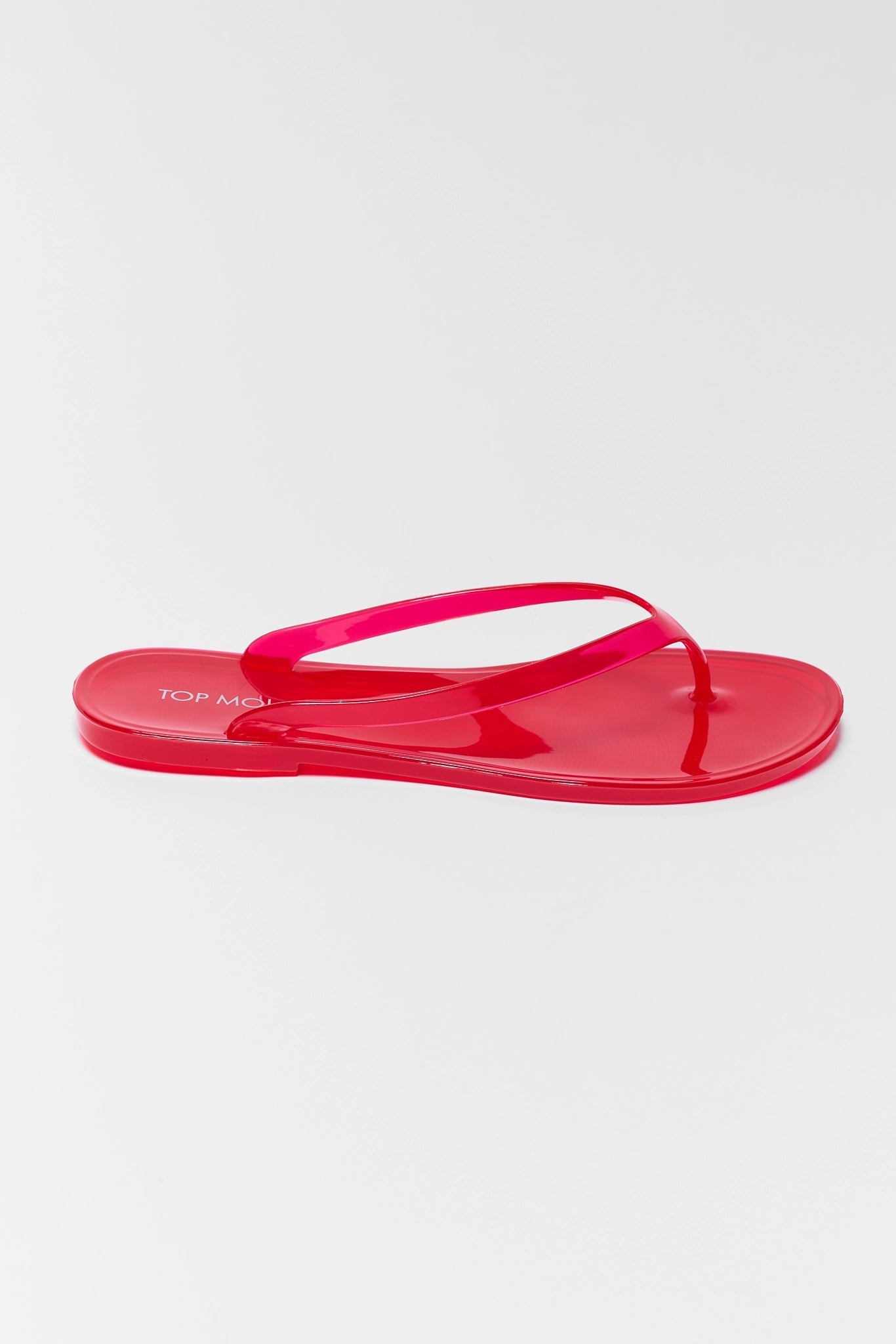 Red sandal with branding on a white background
