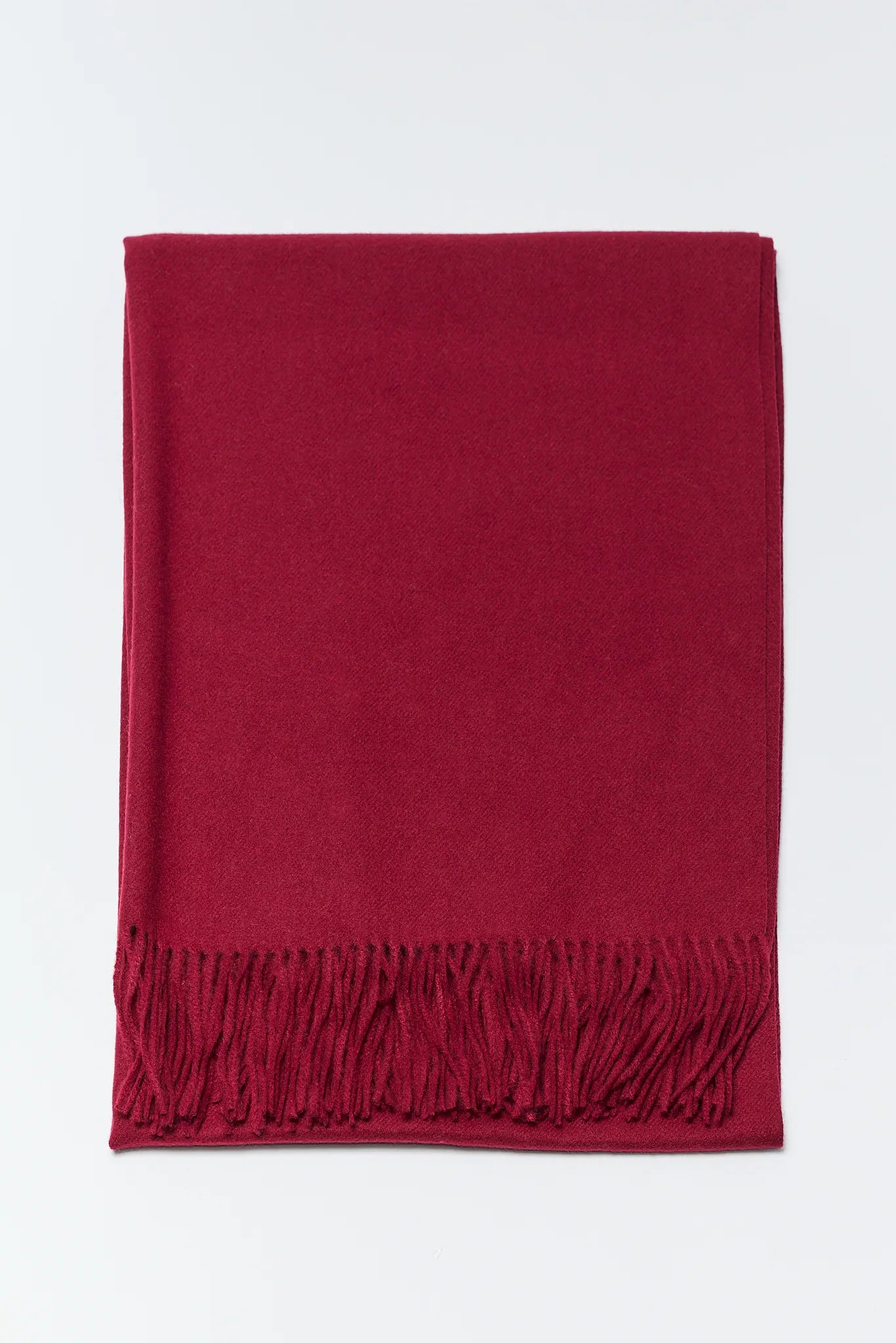 Red scarf with fringes on a white background