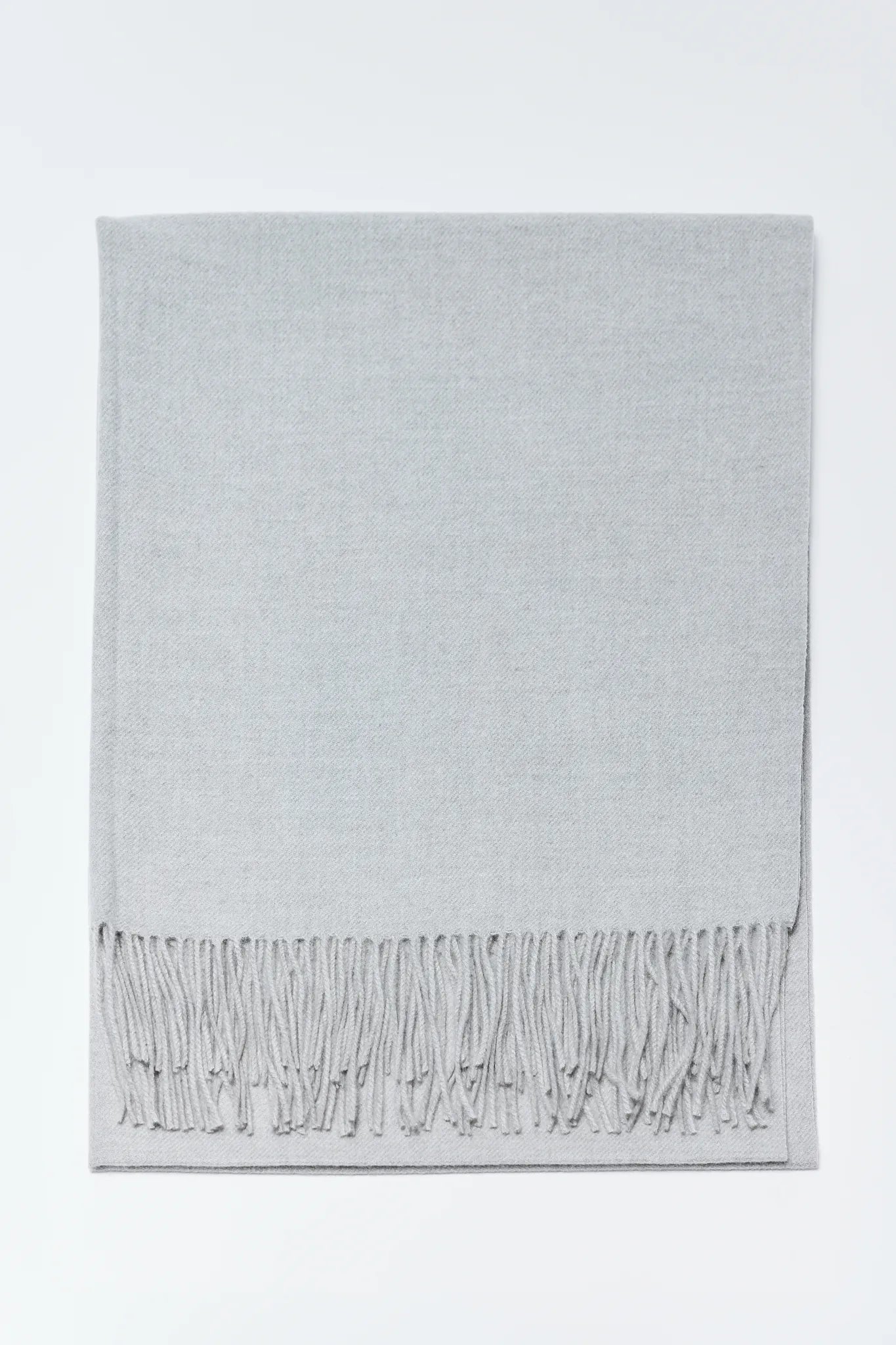 Gray throw blanket with fringes on a white background