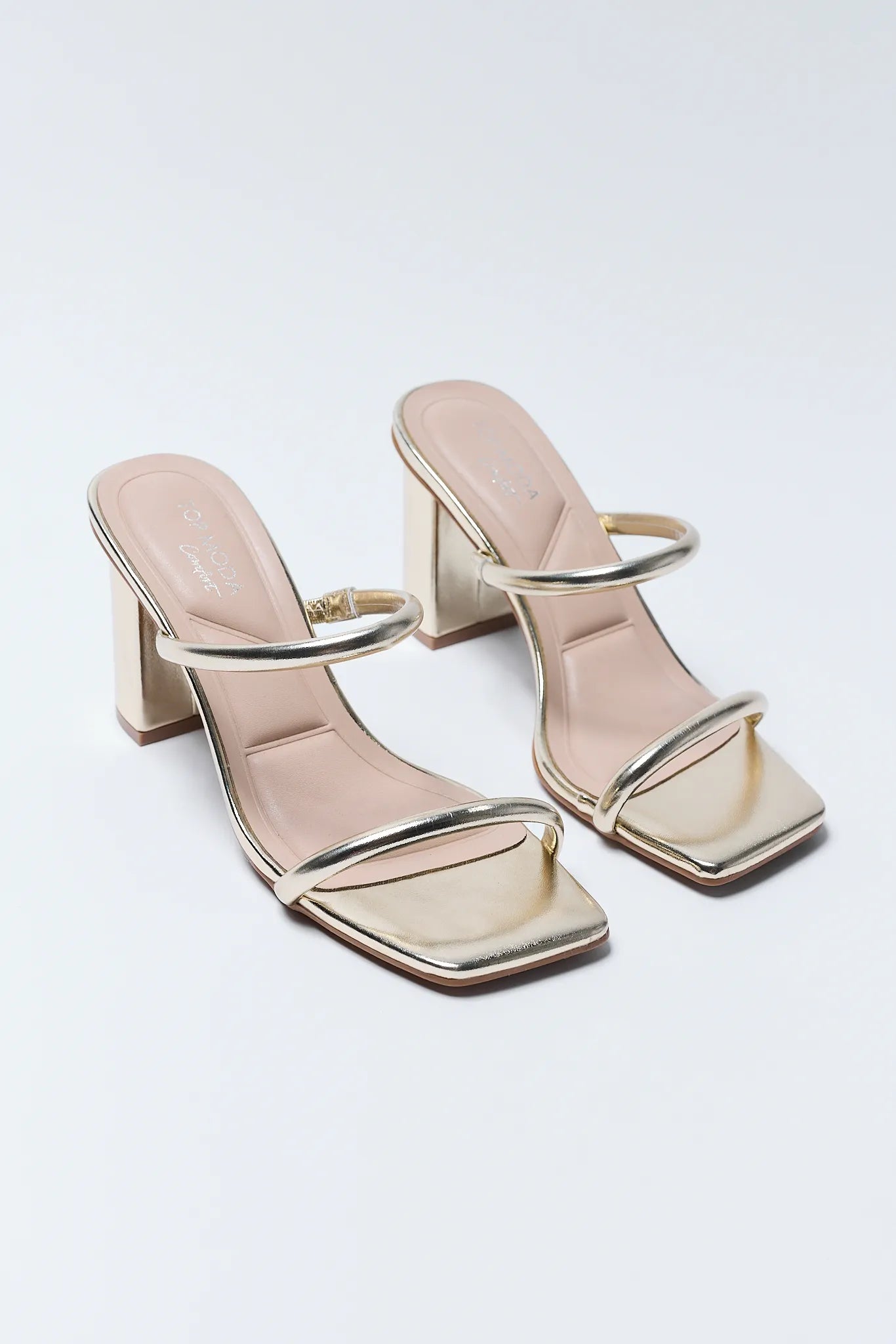 Pair of Kayce Gold Block Heels with metallic accents on a light background