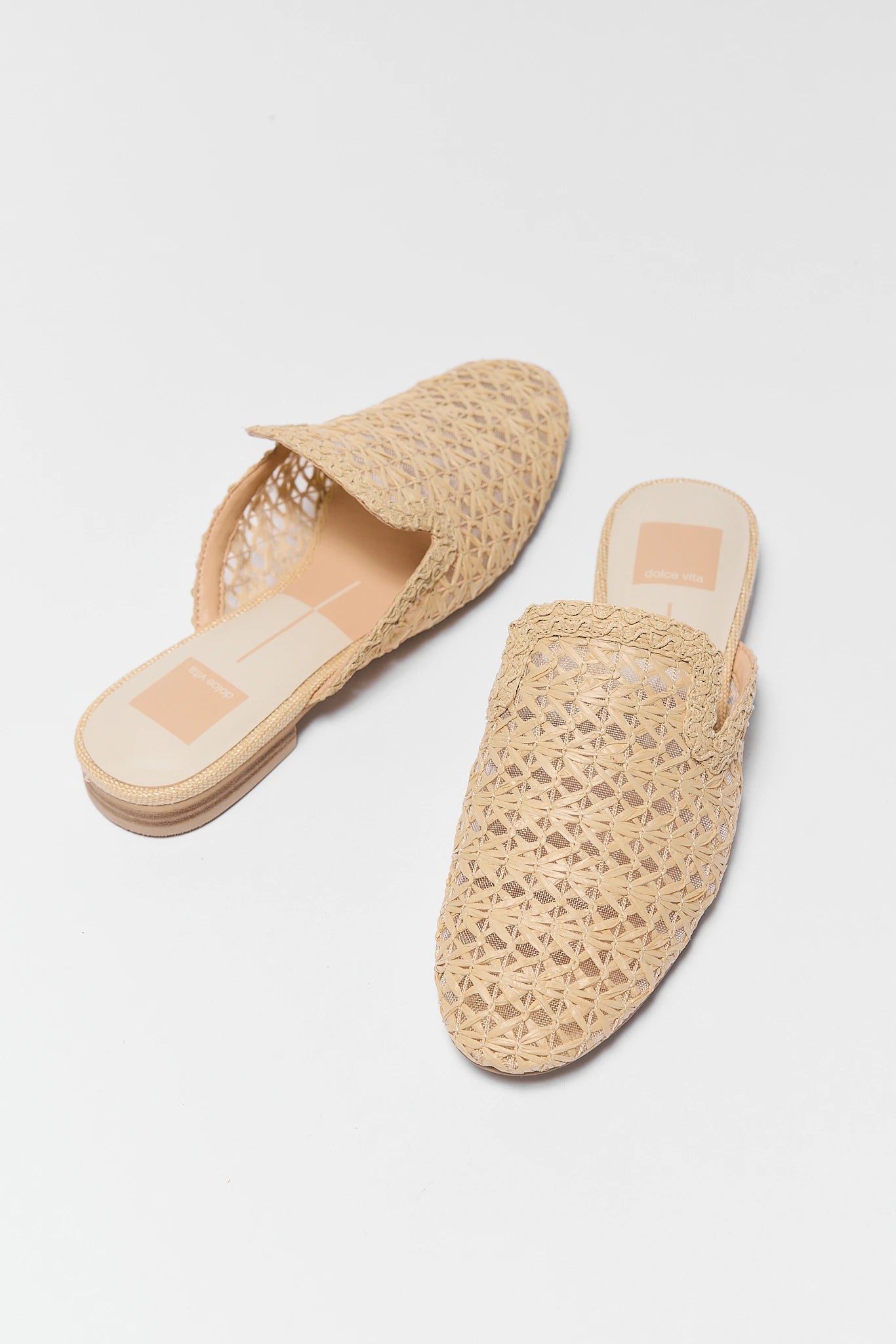 Pair of woven sandals on a light gray background