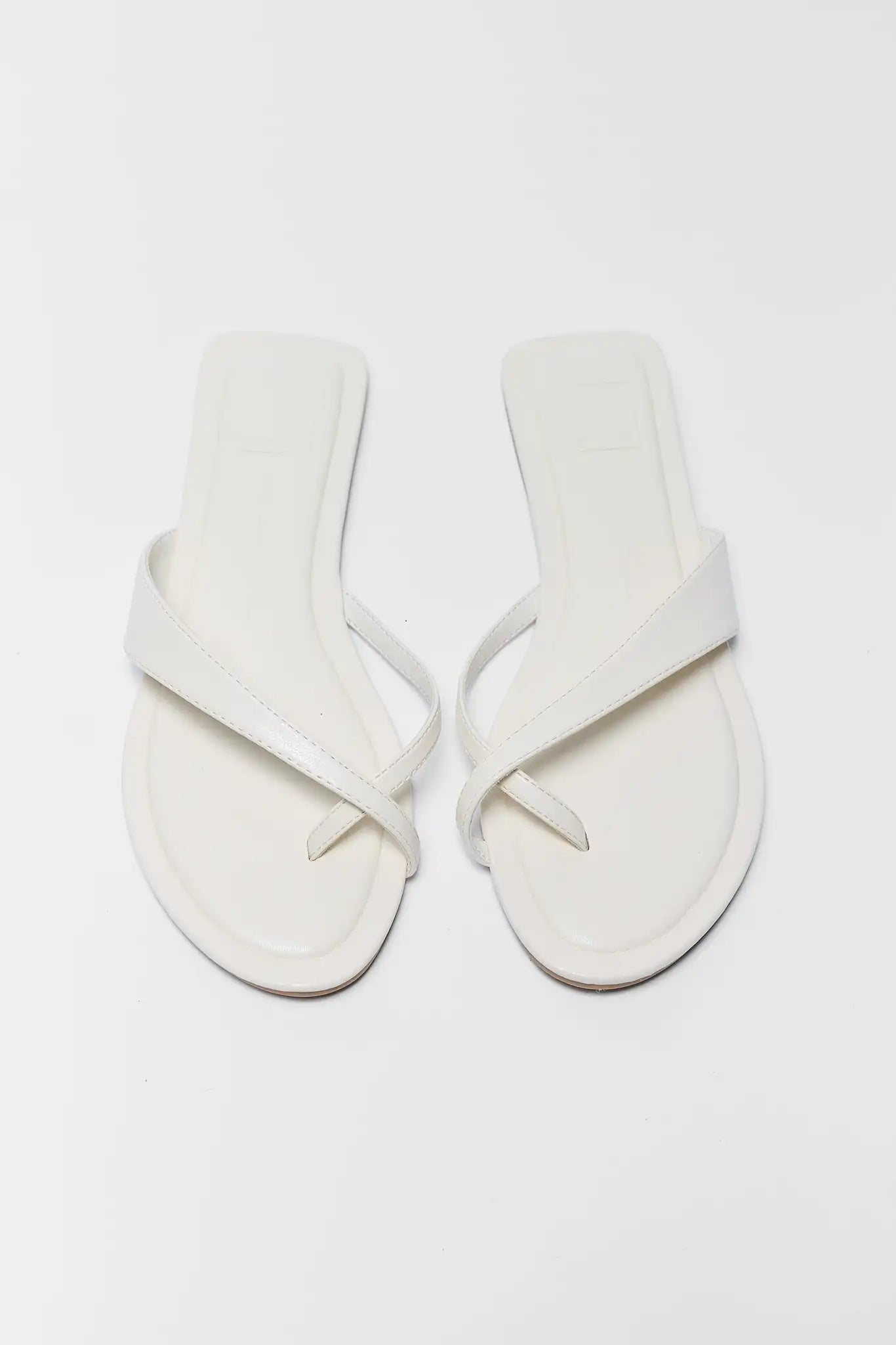 Pair of white sandals on a light gray background two
