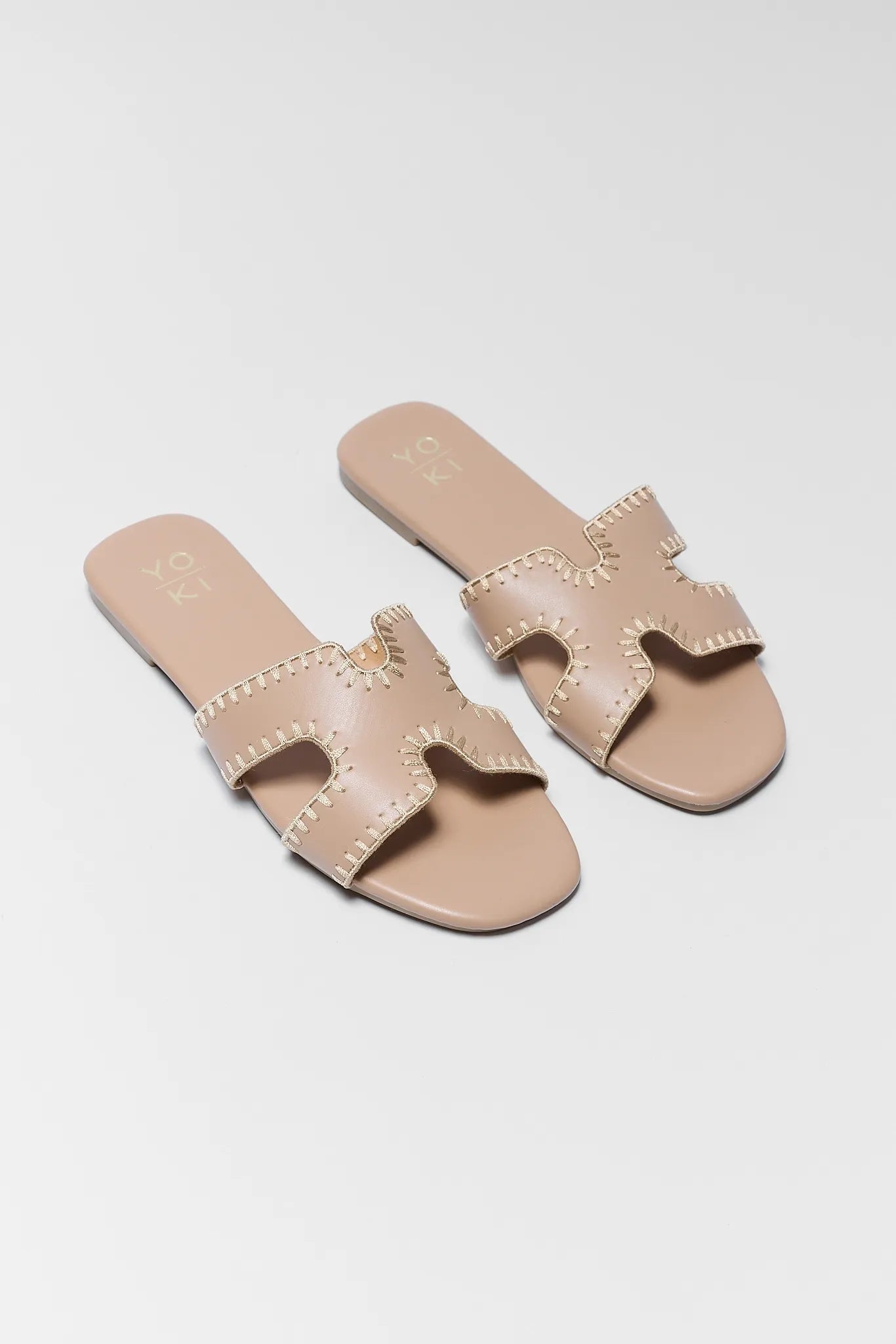 two Leslie Tan Faux Leather Sandals on white background