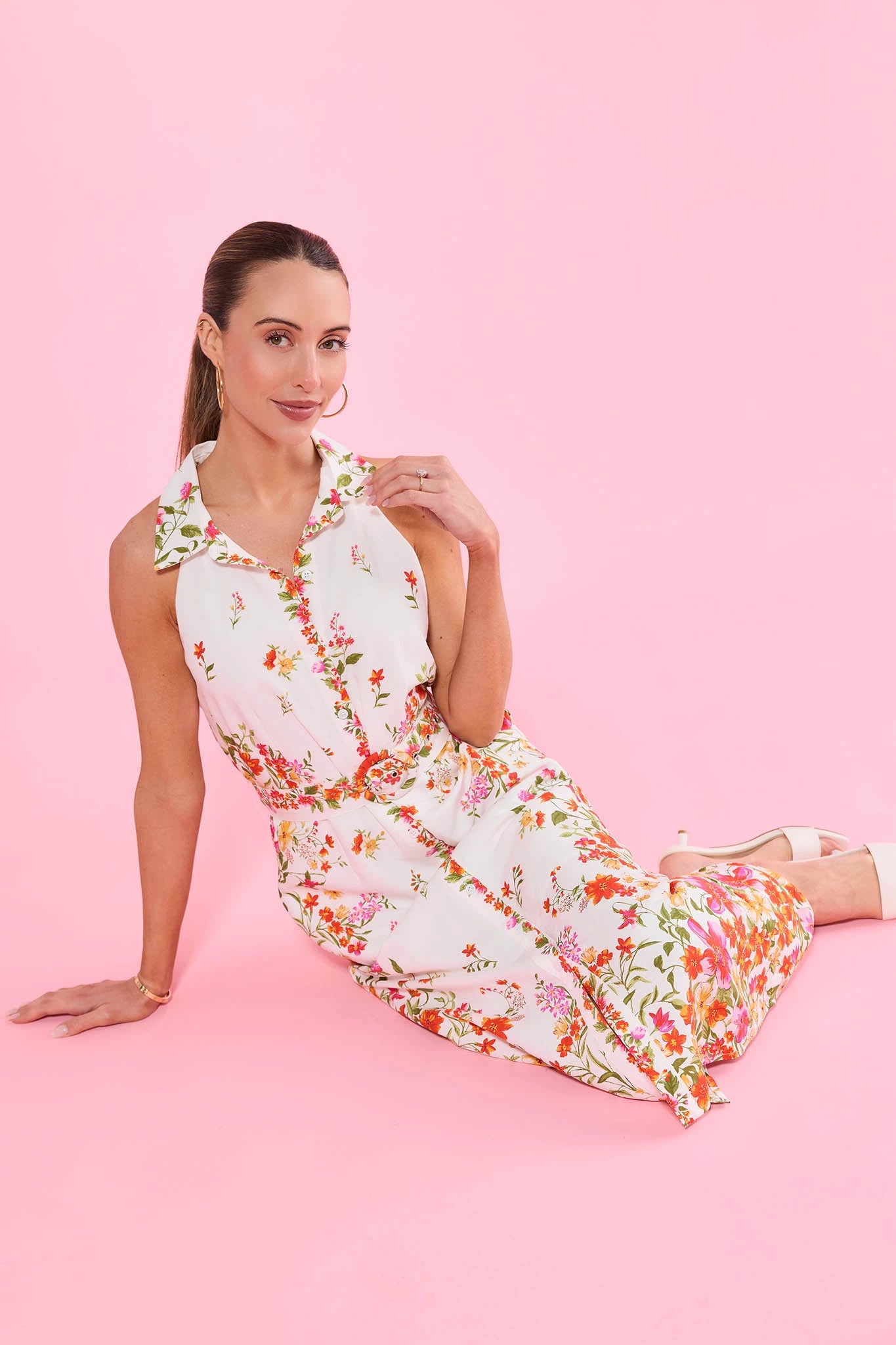 Woman wearing a floral dress on a pink background