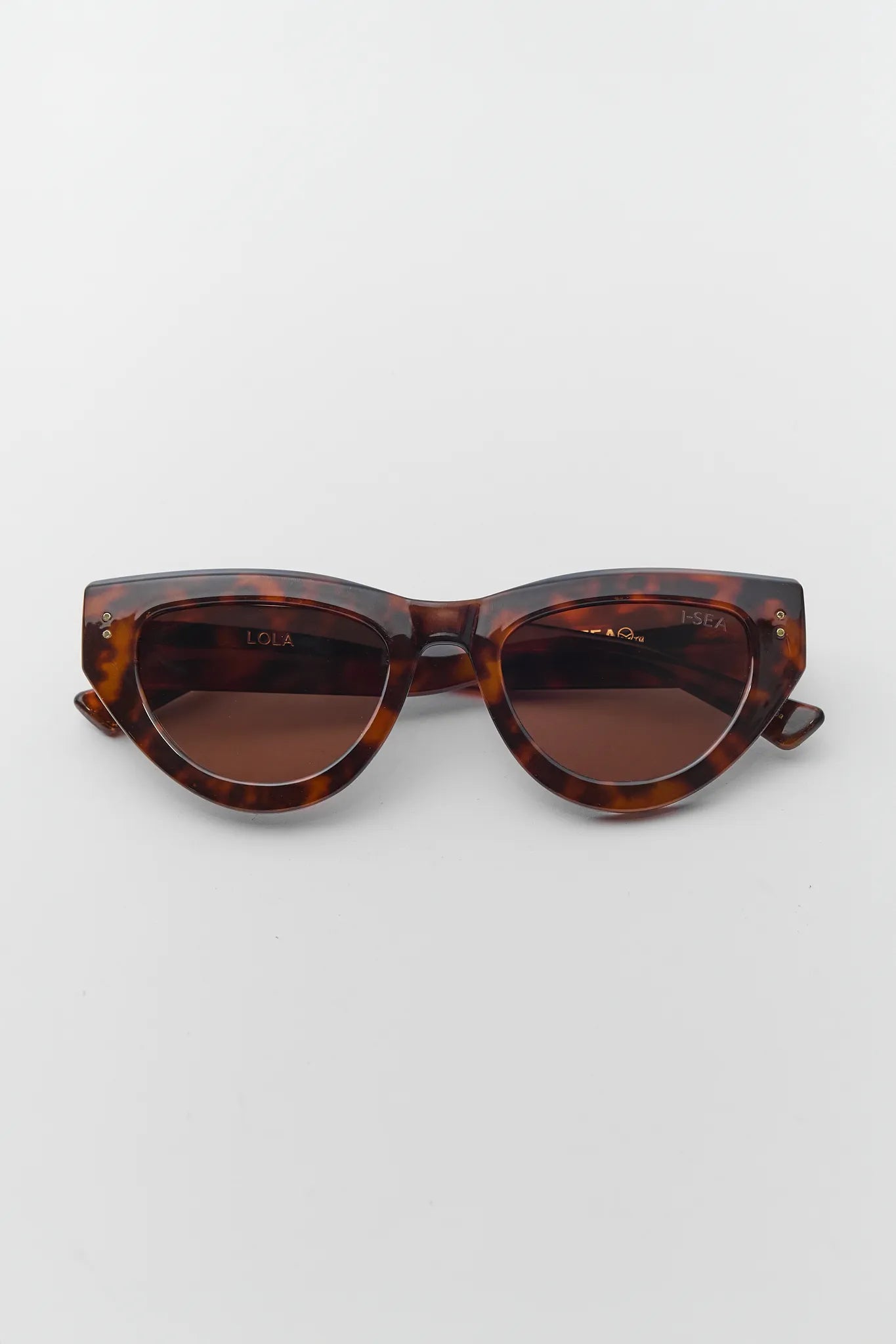 Tortoiseshell cat-eye sunglasses on a light gray background