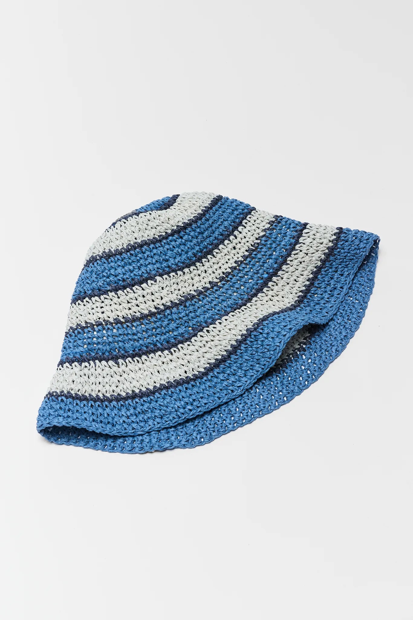 Blue and white striped knitted hat on a light gray background