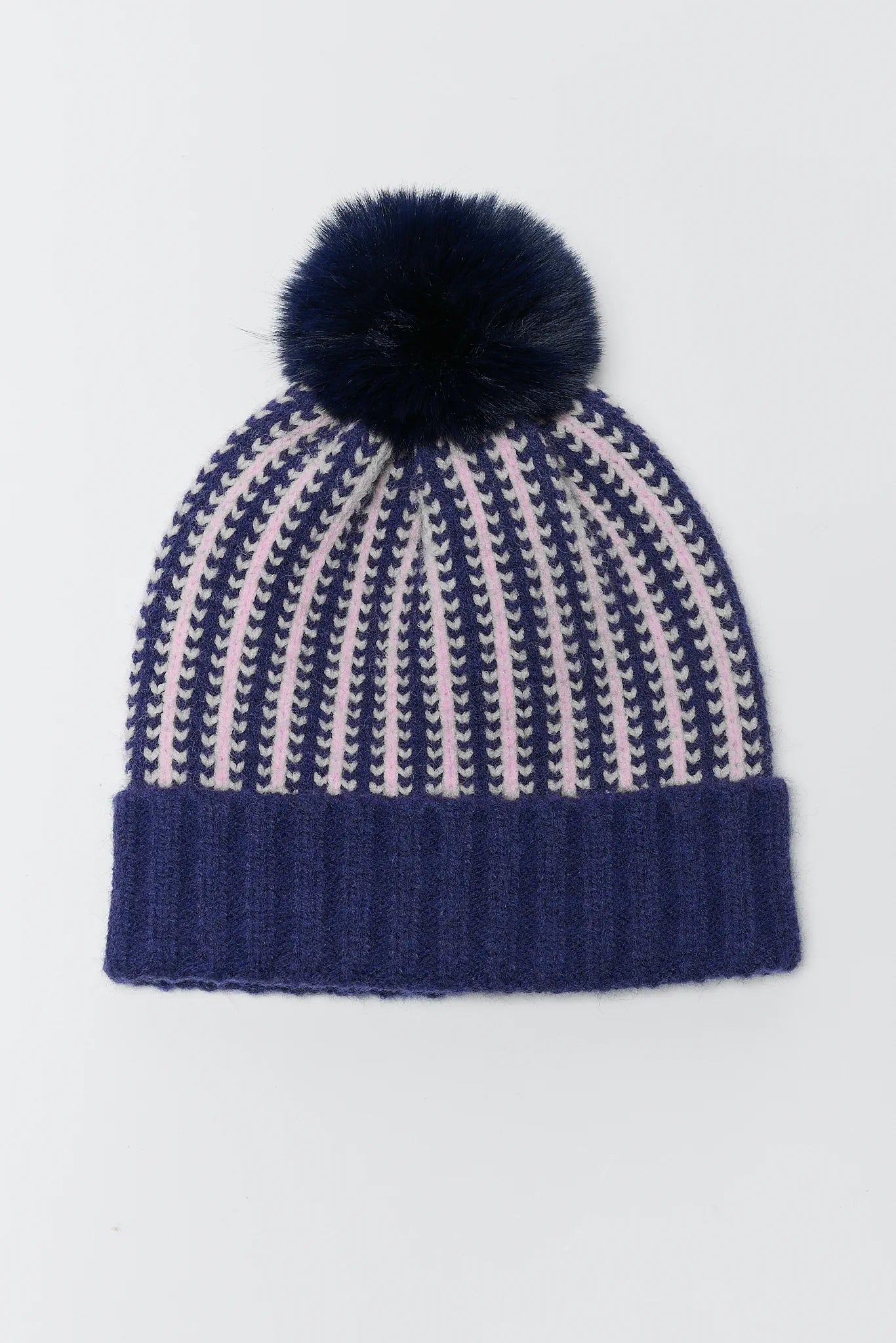 Navy and beige striped knit hat with a navy pom-pom on a light gray background