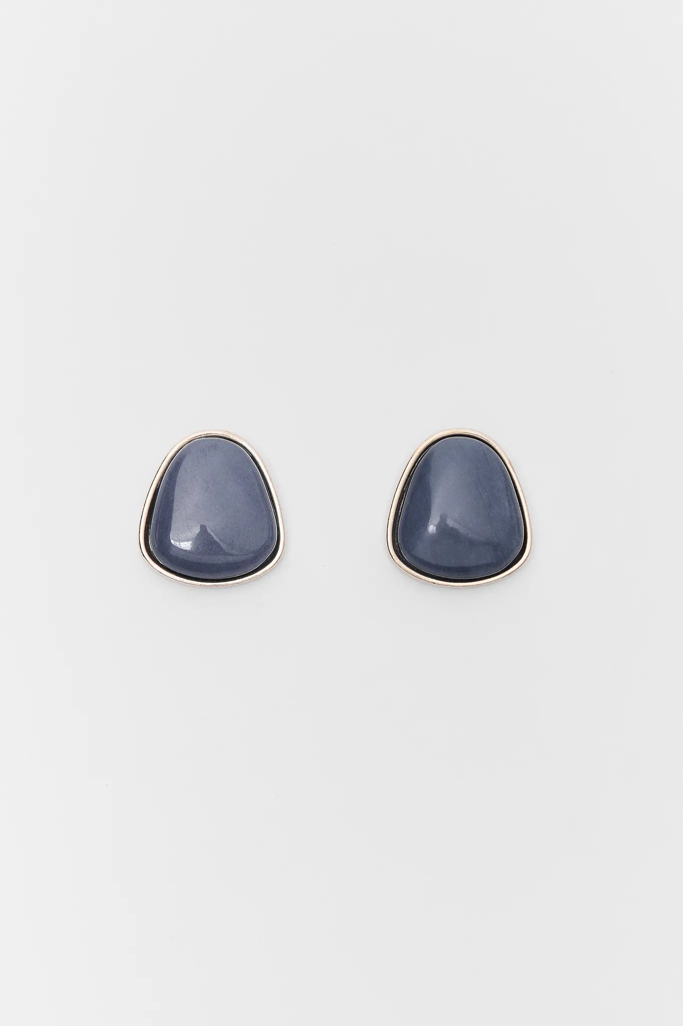 Pair of blue teardrop earrings on a light gray background