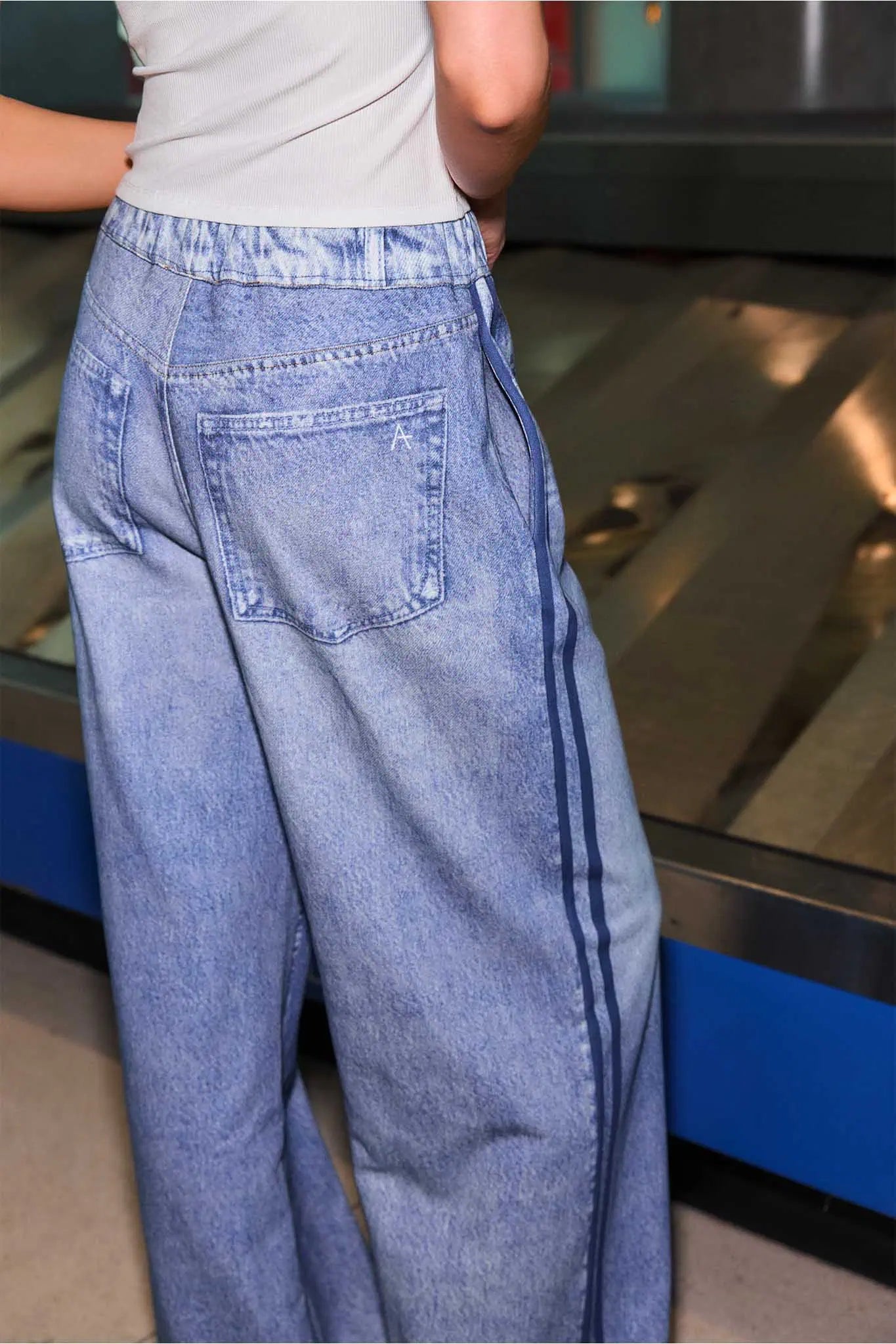 Person wearing blue jeans with a blurred background