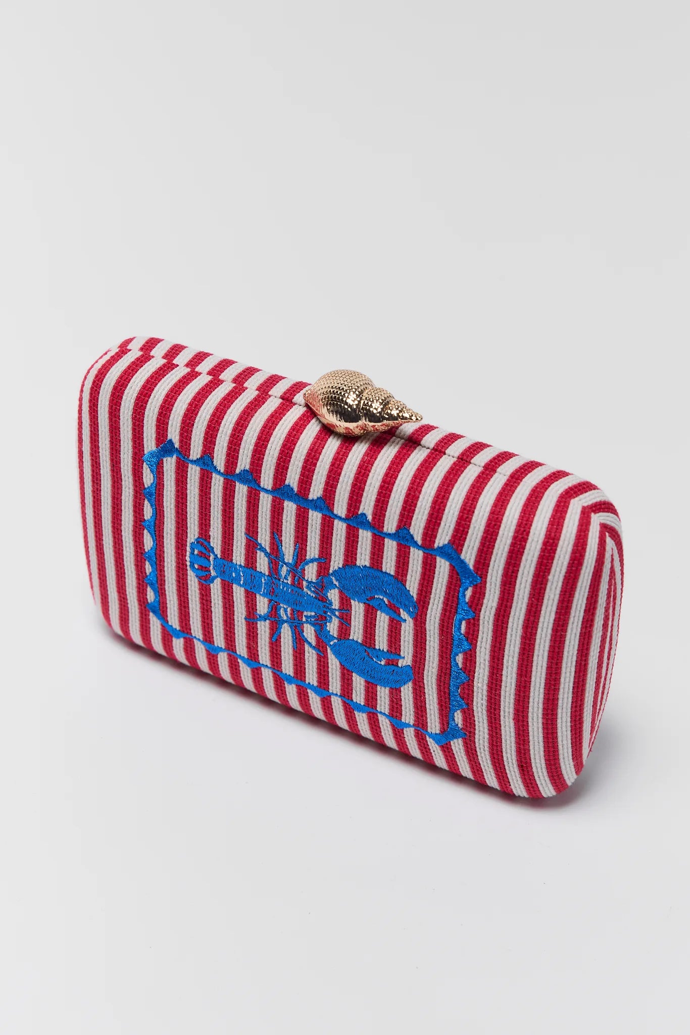 close up Red and white striped clutch with blue lobster design on a light gray background