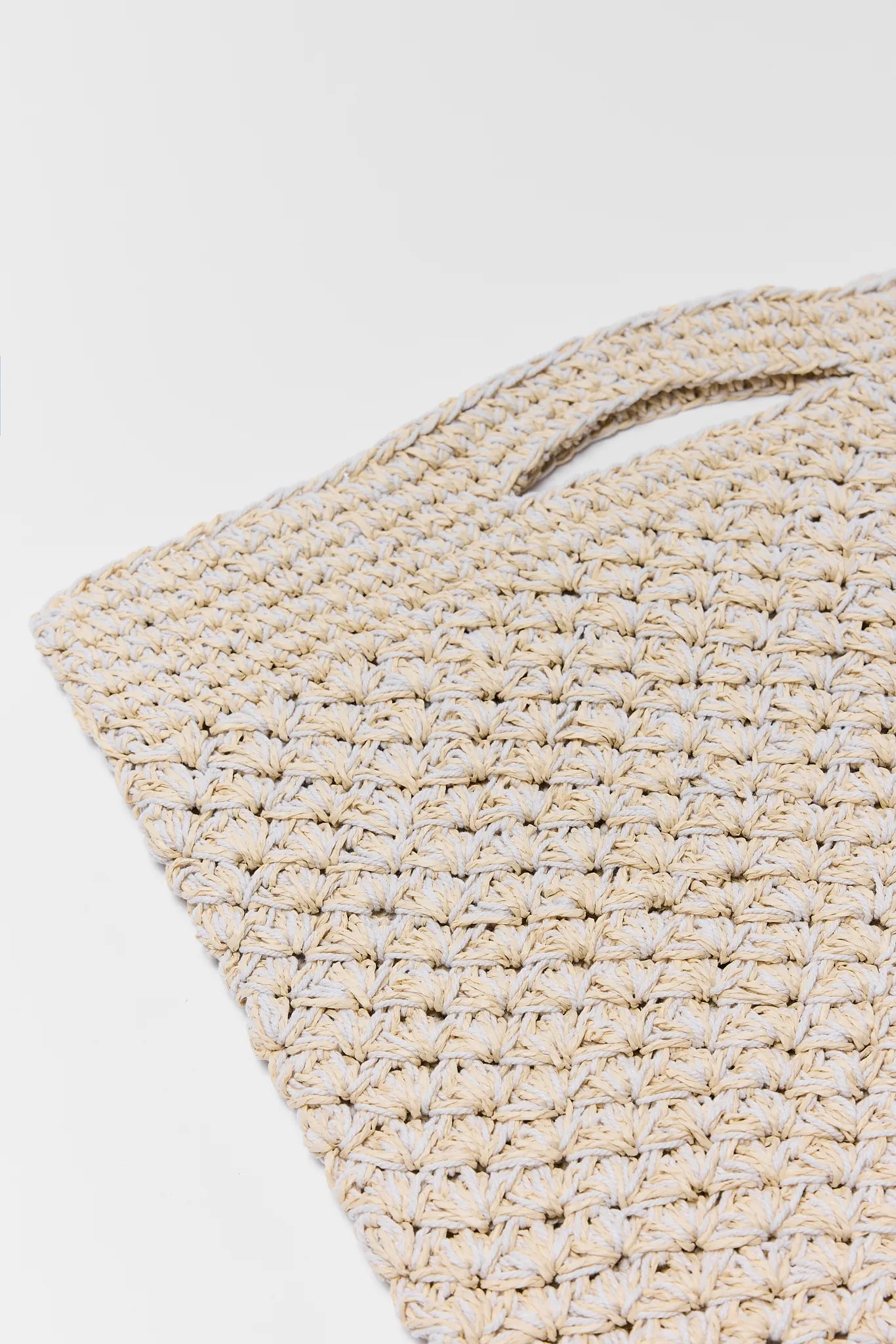 Close-up of a textured beige rug on a white background