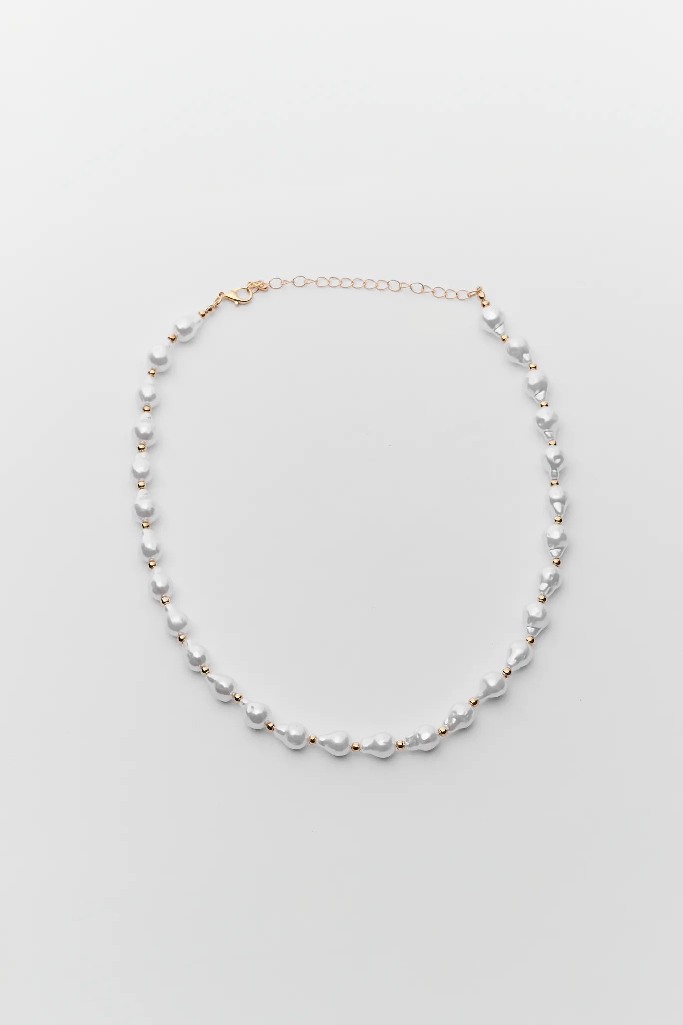 Pearl necklace on a light gray background