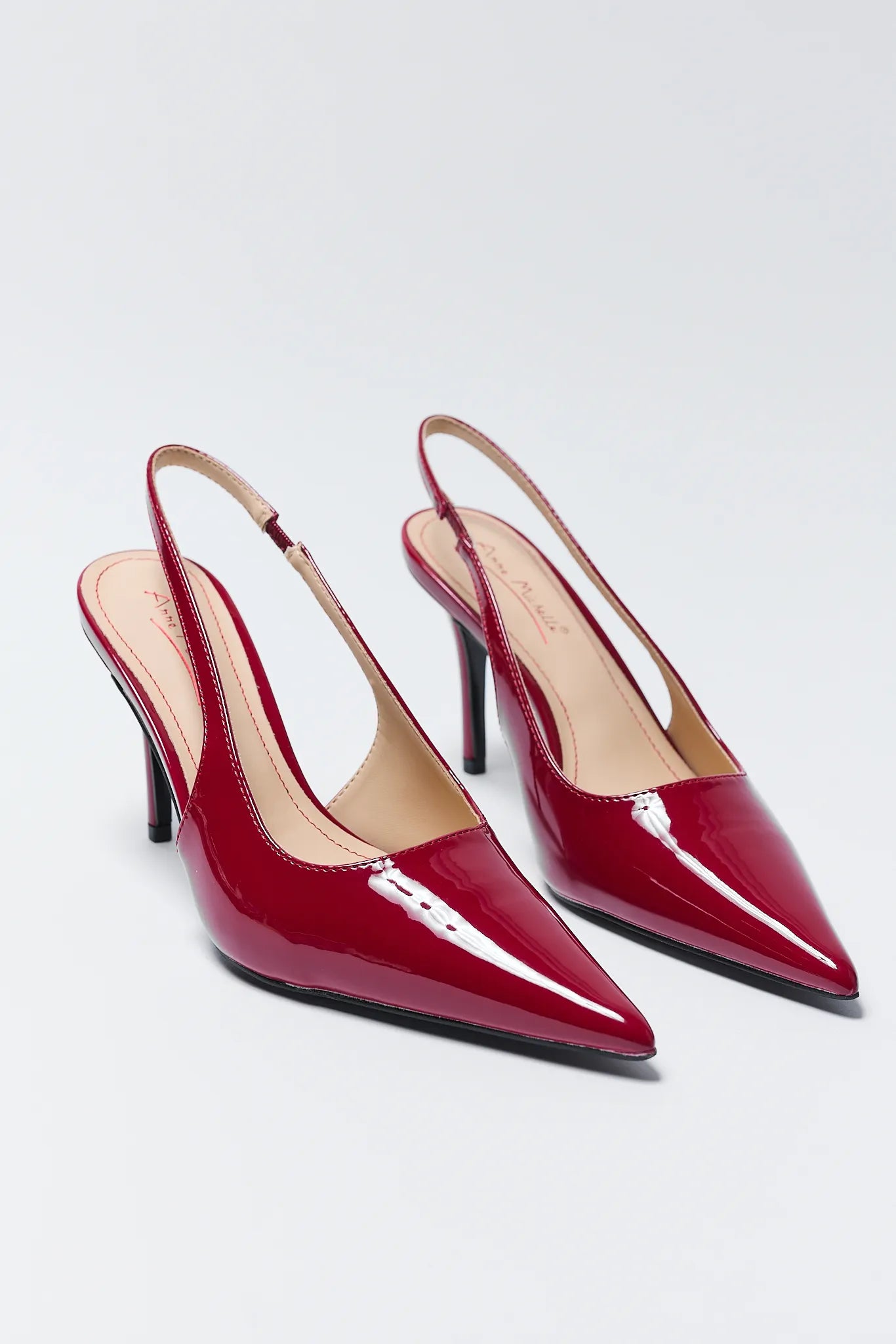 Pair of Missy Red Pointed Toe Heels on a light gray background