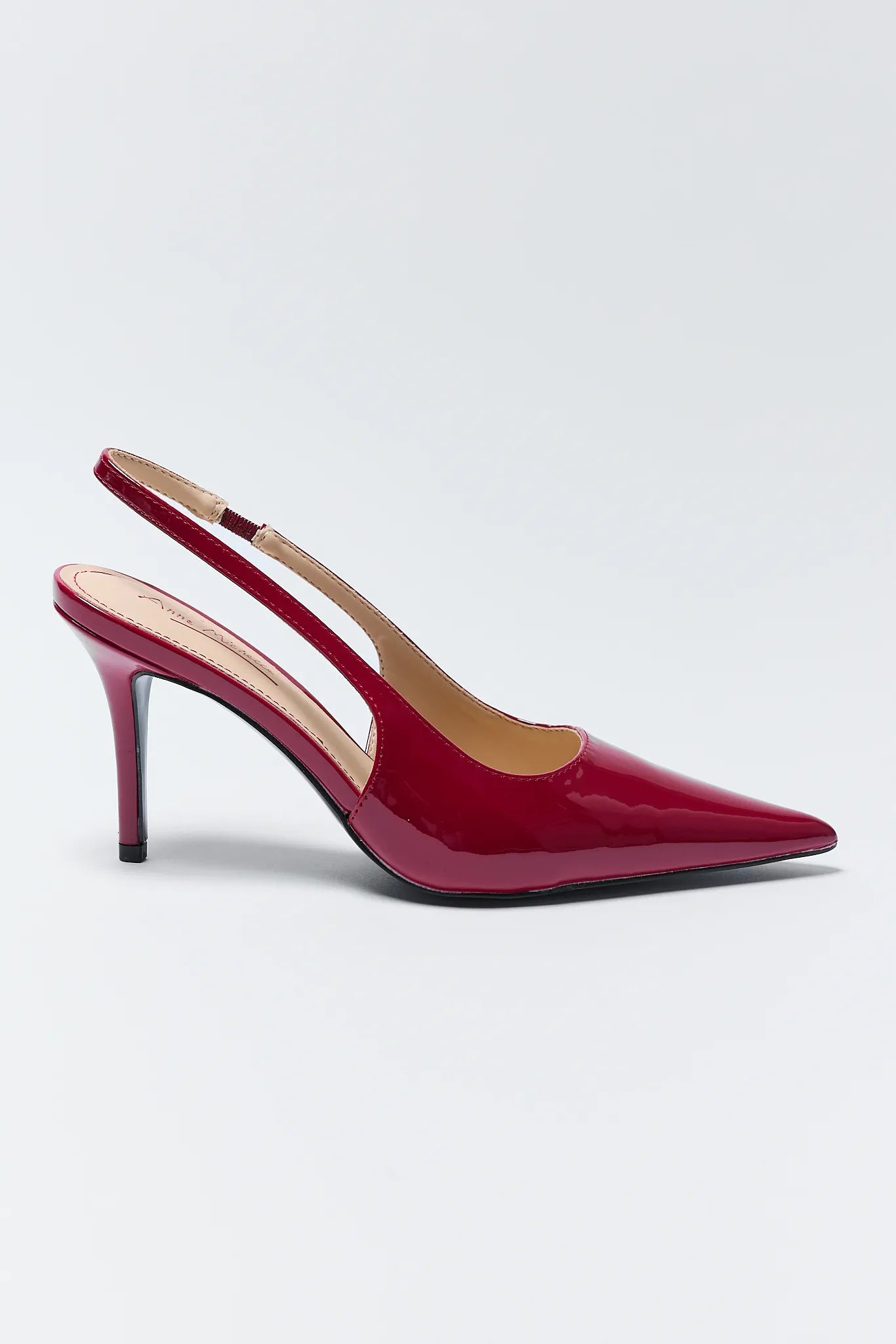 Pair of Missy Red Pointed Toe Heels on a light gray background