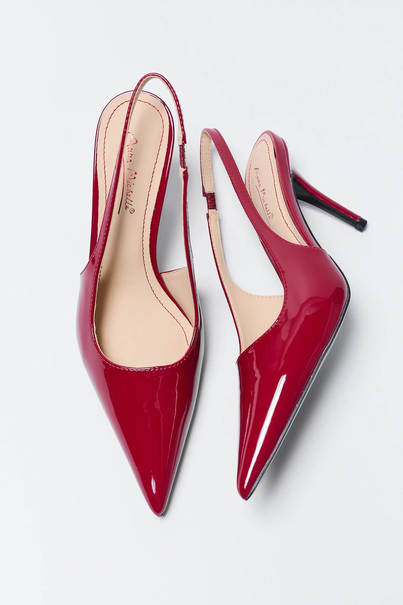 Pair of Missy Red Pointed Toe Heels on a light gray background