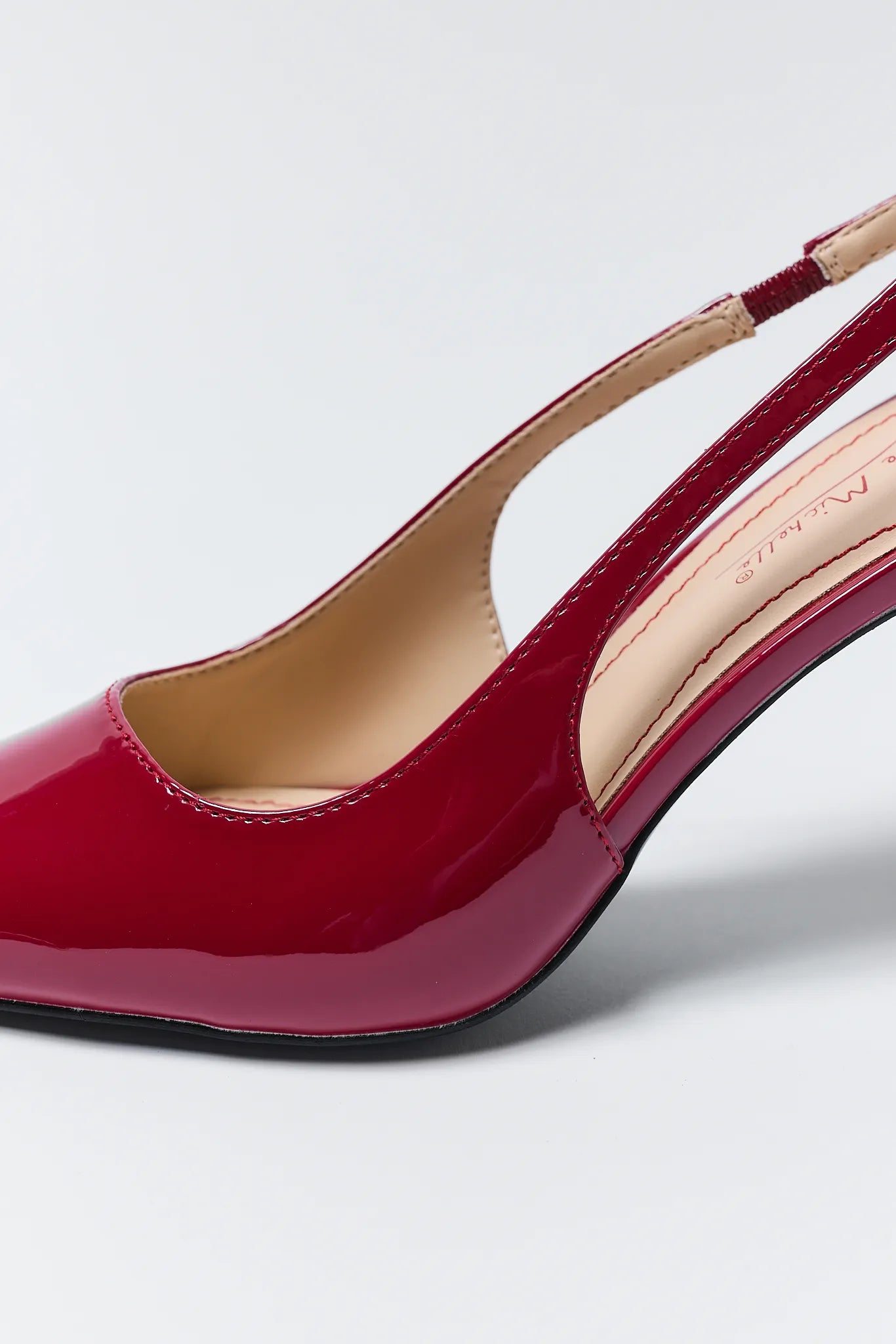 Pair of Missy Red Pointed Toe Heels on a light gray background