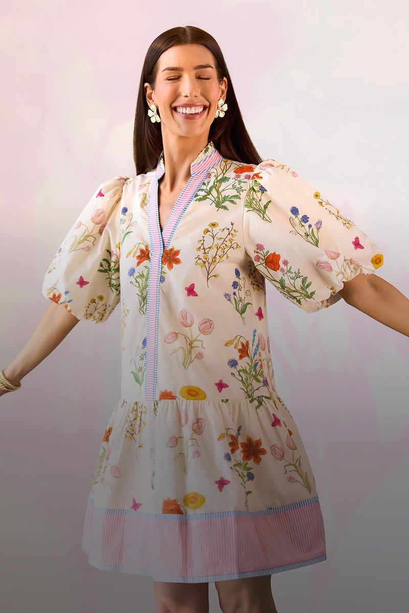 Woman wearing a floral dress with a plain background
