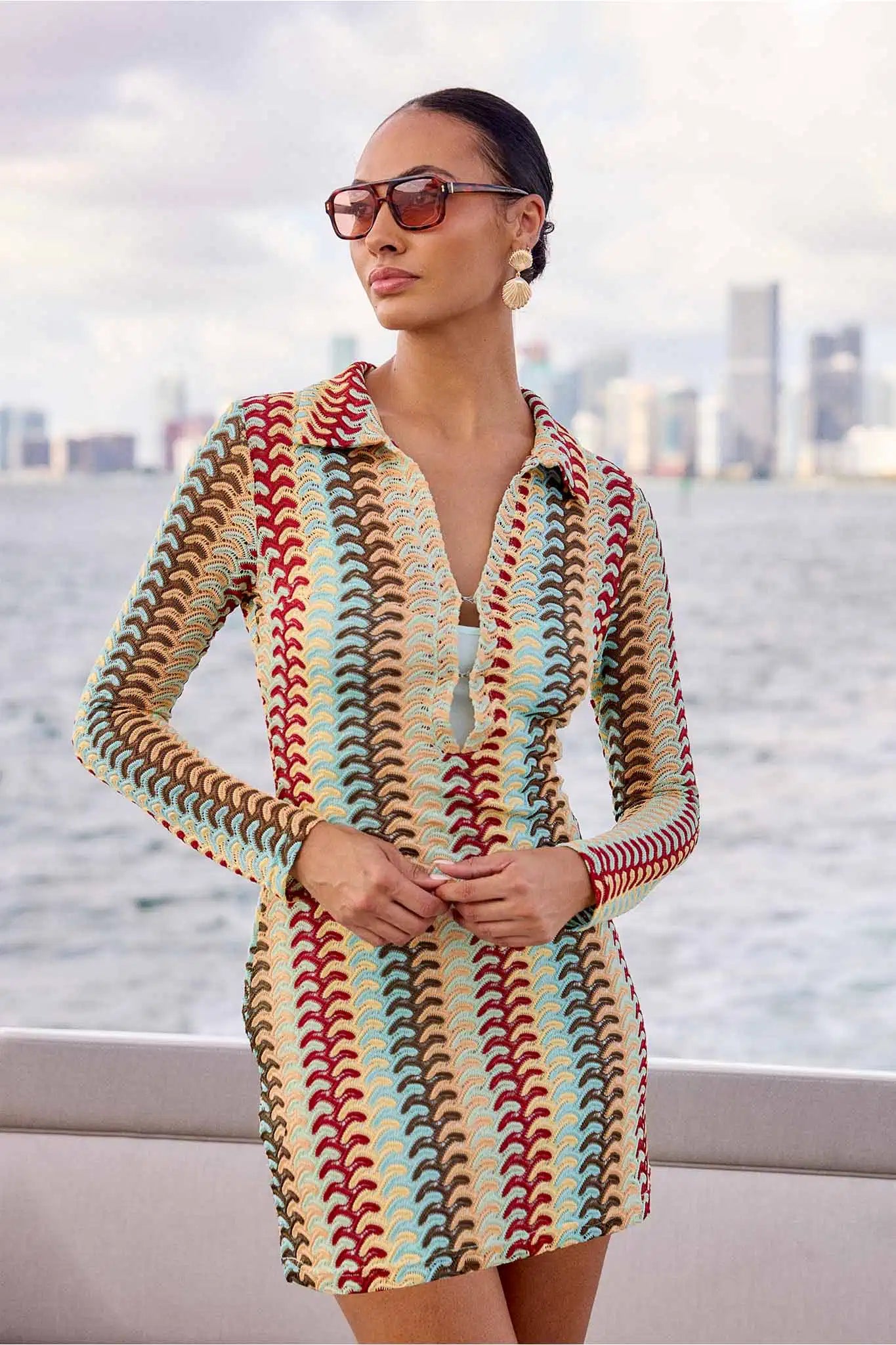 Women wearing knit molly multicolor dress with city buildings in background