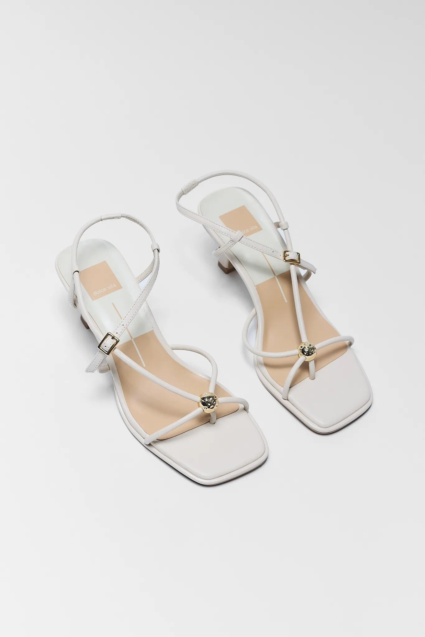 two Mylee Cream Strappy Kitten Heels on white background