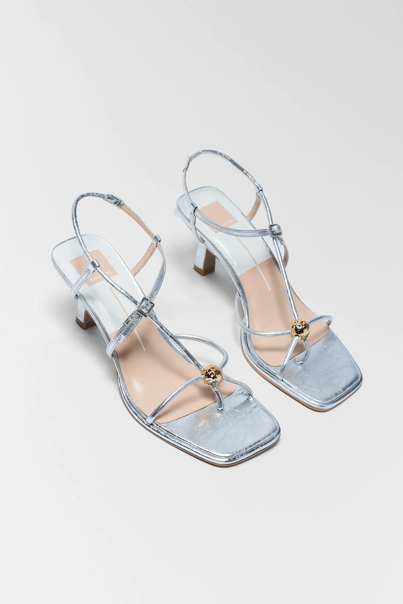 two Mylee Silver Strappy Kitten Heels on white background