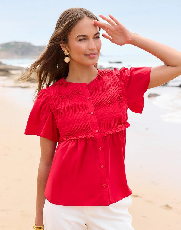 Woman wearing a red blouse on a beach navigation