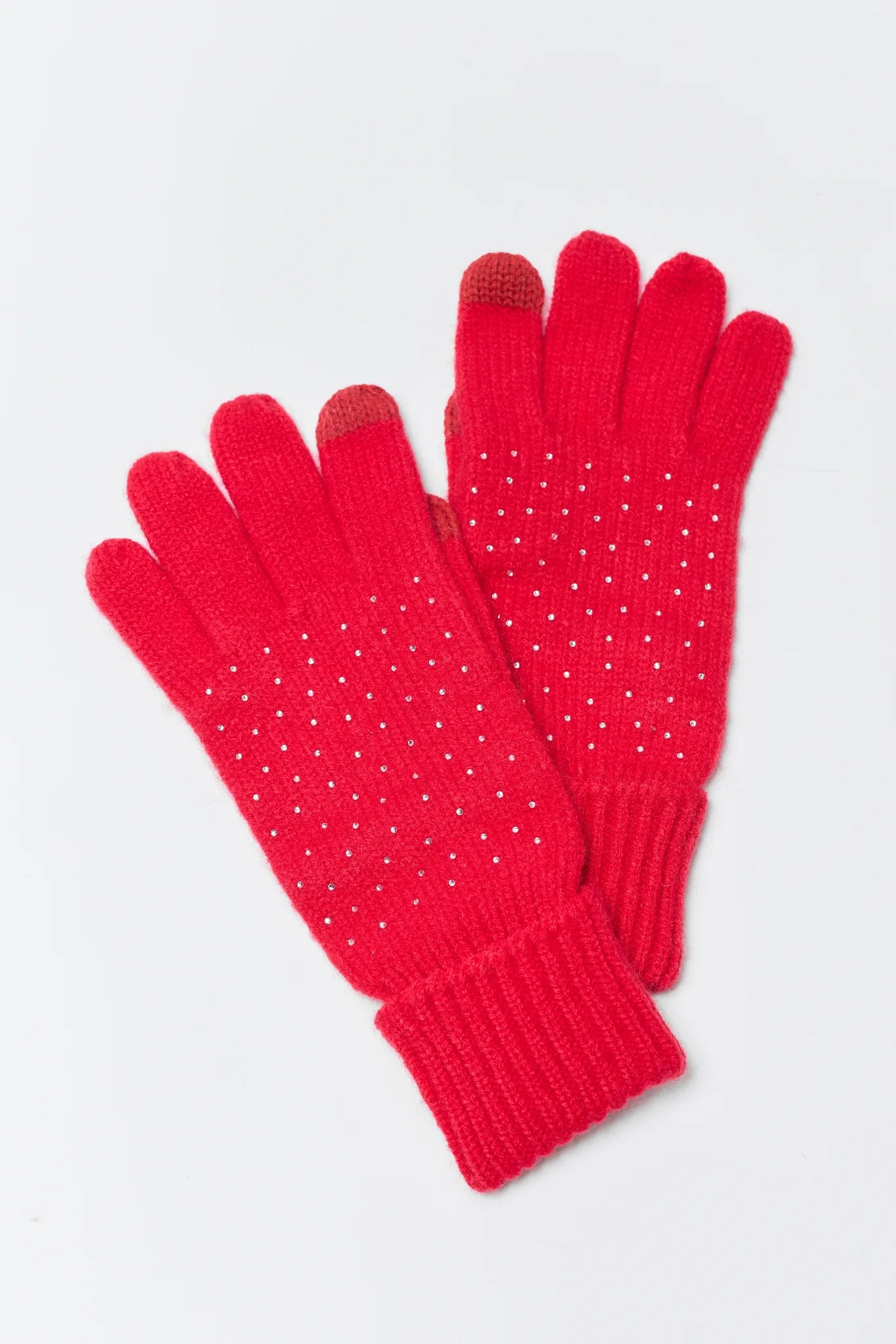 Pair of red gloves with small white dots on a light gray background