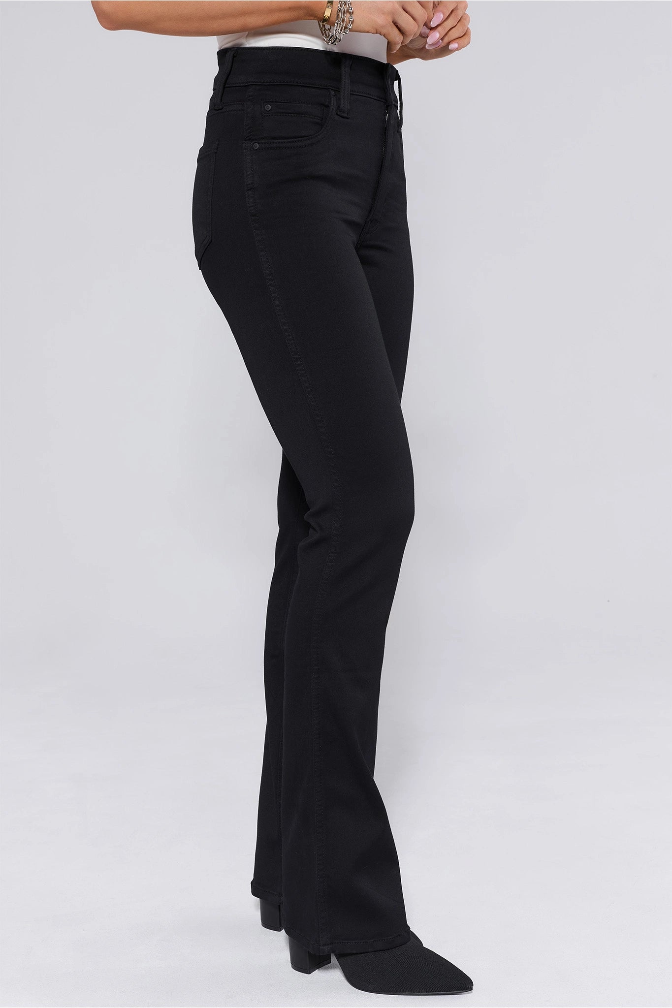 Black flared Natalie Jeans worn by a person on a white background