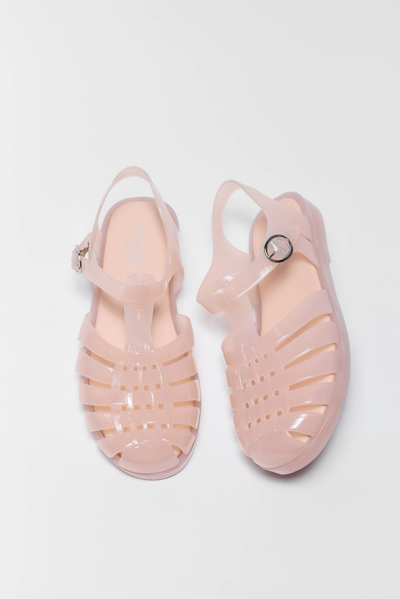 Pair of pink jelly sandals on a light gray background