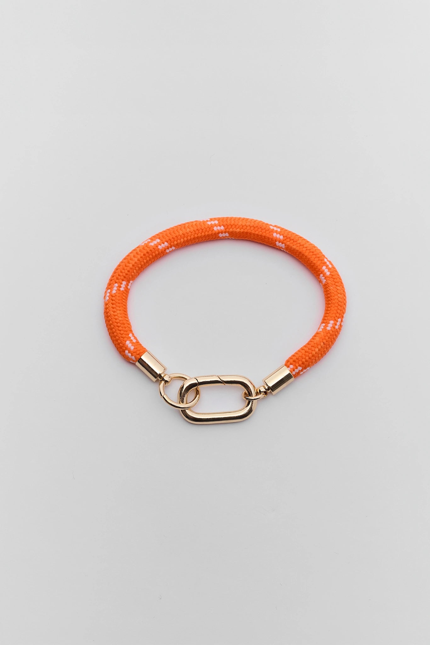 A orange woven rope bracelet with a gold-tone lobster clasp, displayed on a neutral light background.