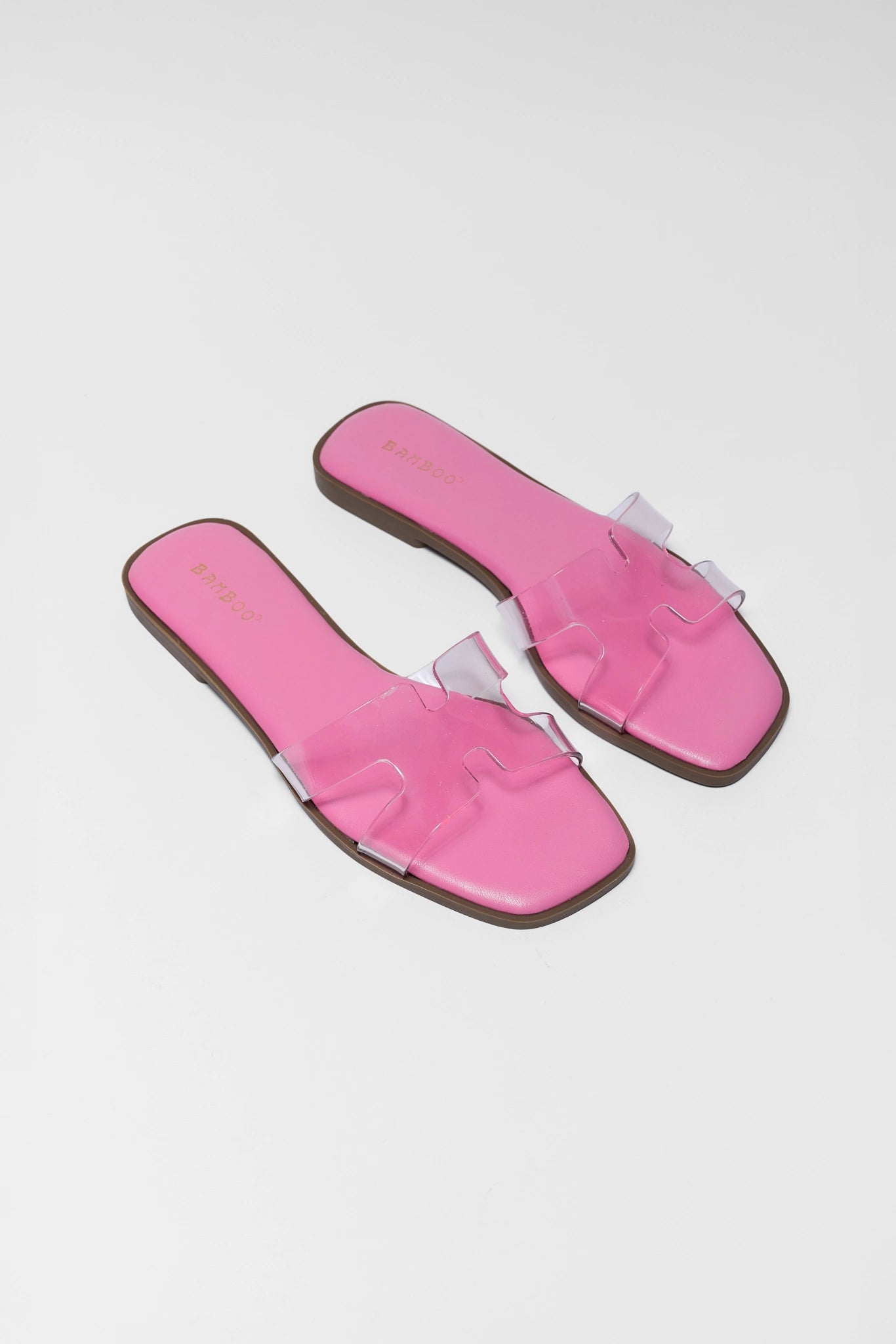 two Pair of pink sandals on a light gray background