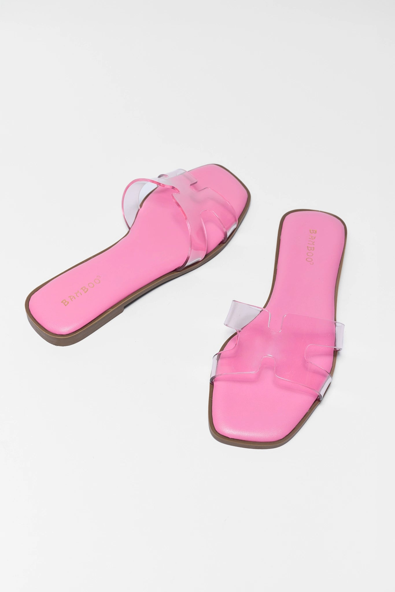 Pair of pink sandals on a white background