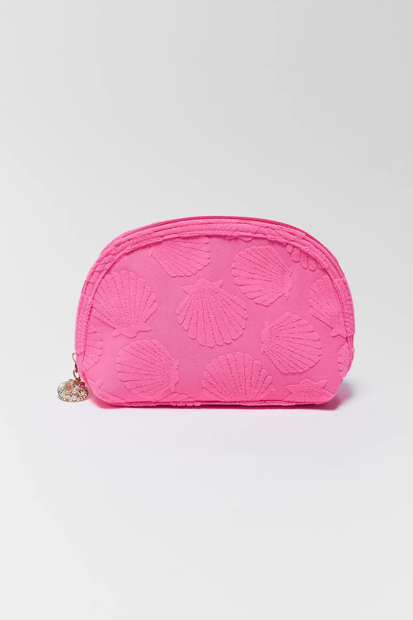 Pink pouch with shell pattern on a light gray background