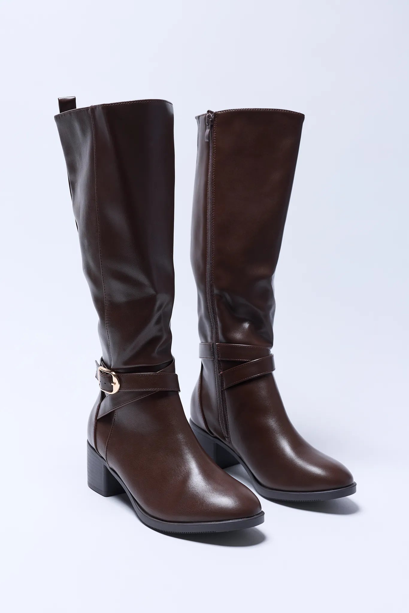 Pair of brown Prudence boots with buckles on a white background