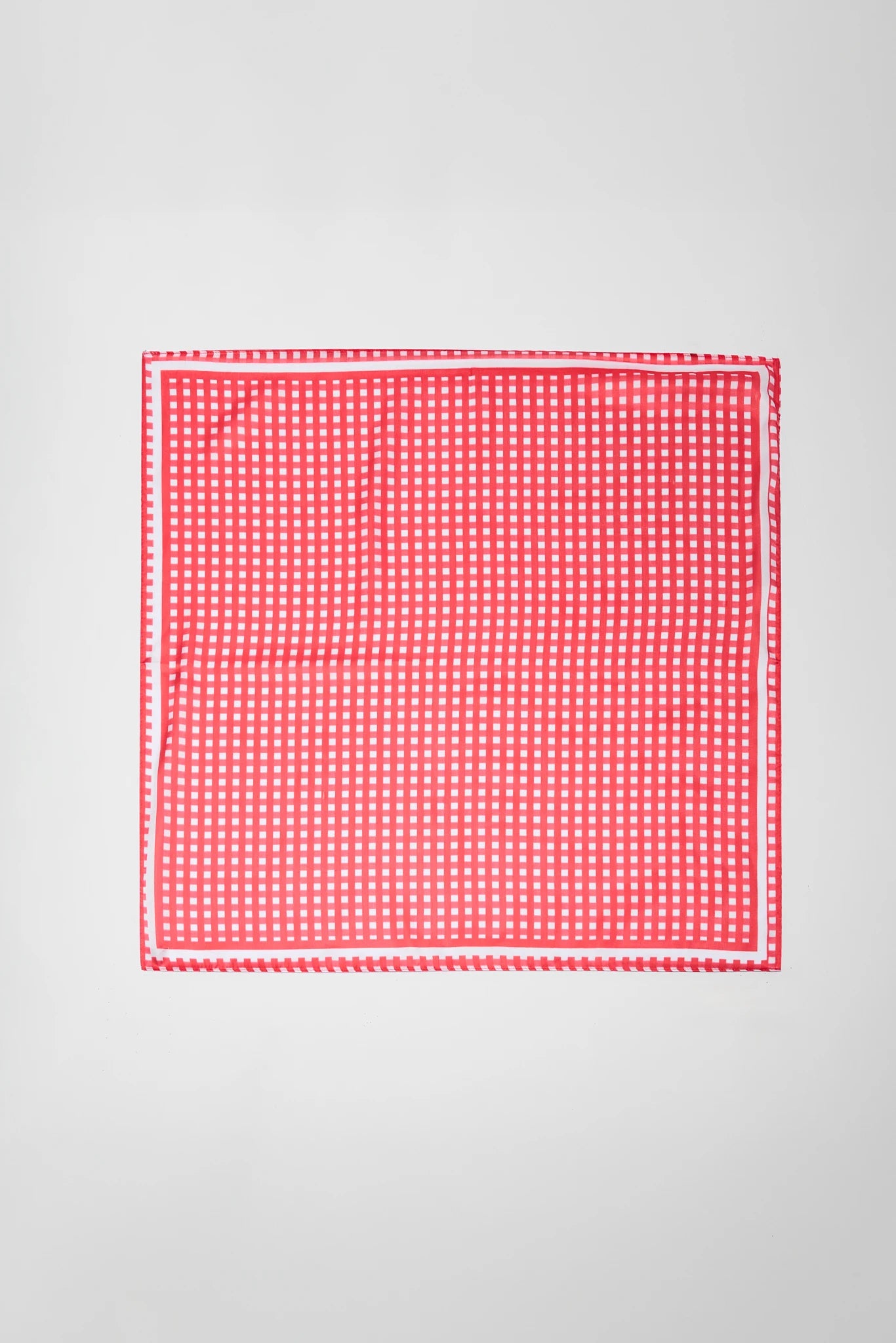 Red and white checkered fabric on a gray background