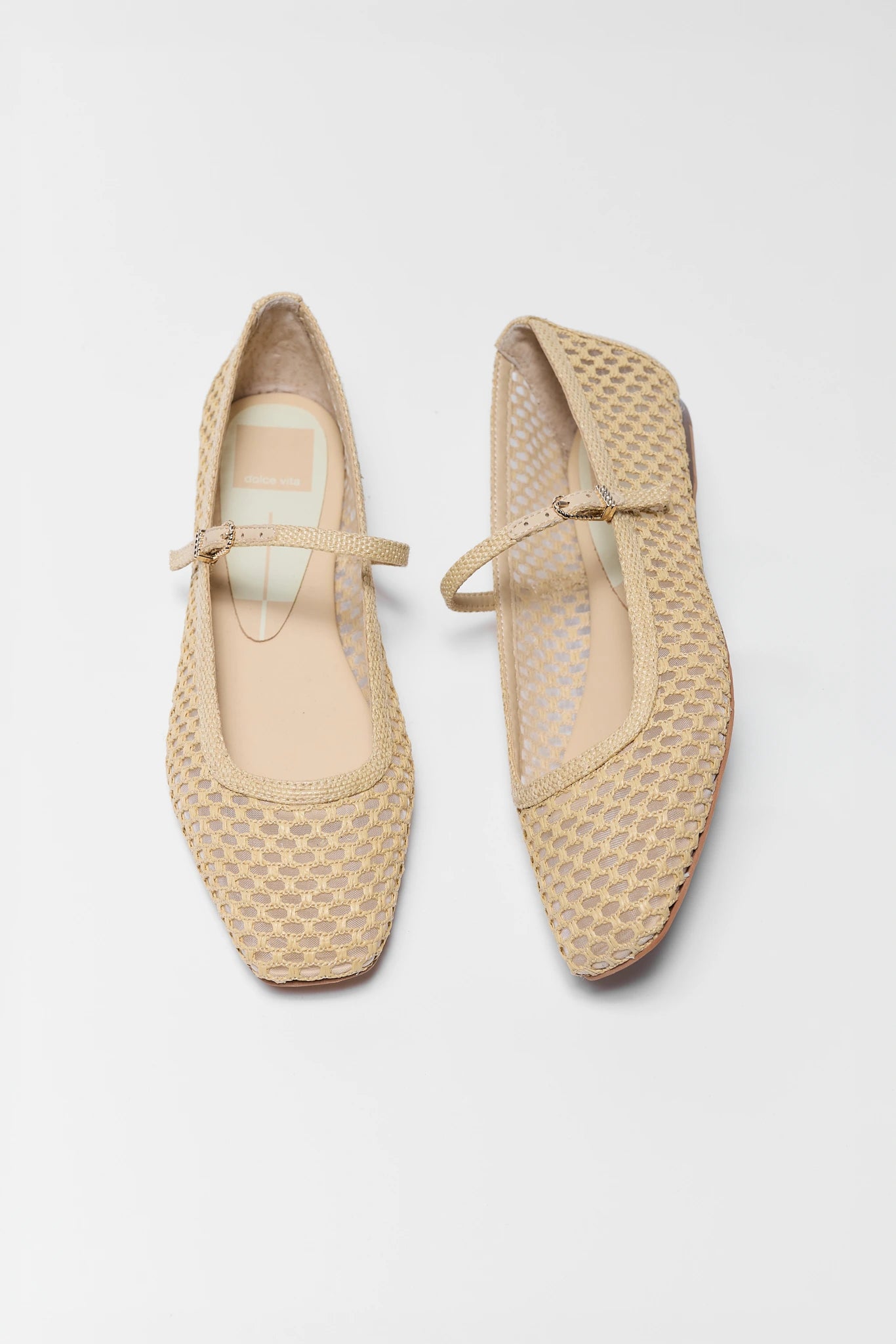 Pair of beige woven shoes on a white background two