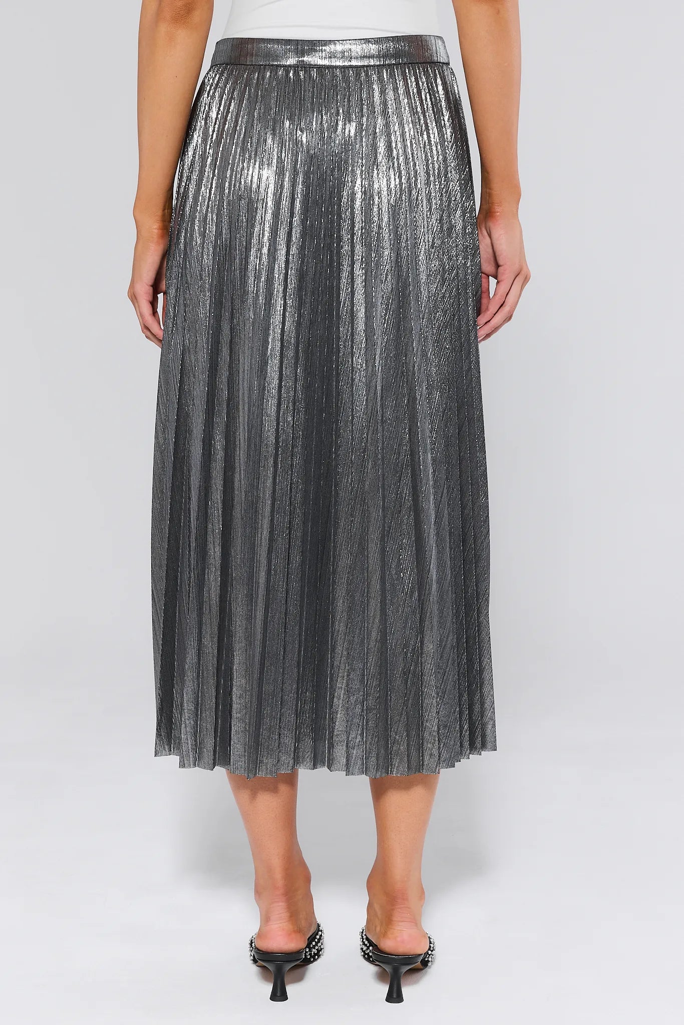 Person wearing a Hensley Silver Pleated Midi Skirt on a white background
