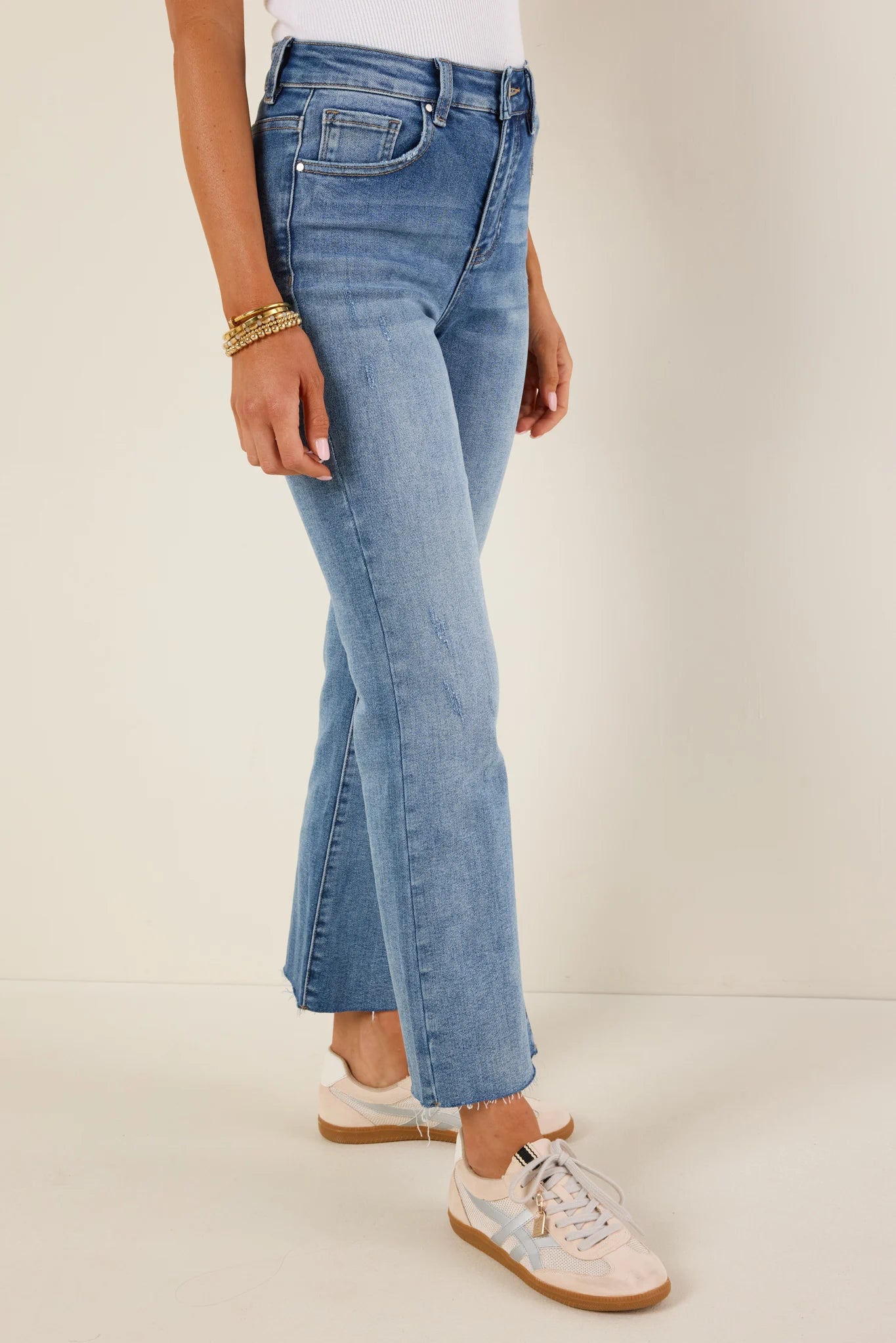 Person wearing light blue aliyah jeans on a plain background
