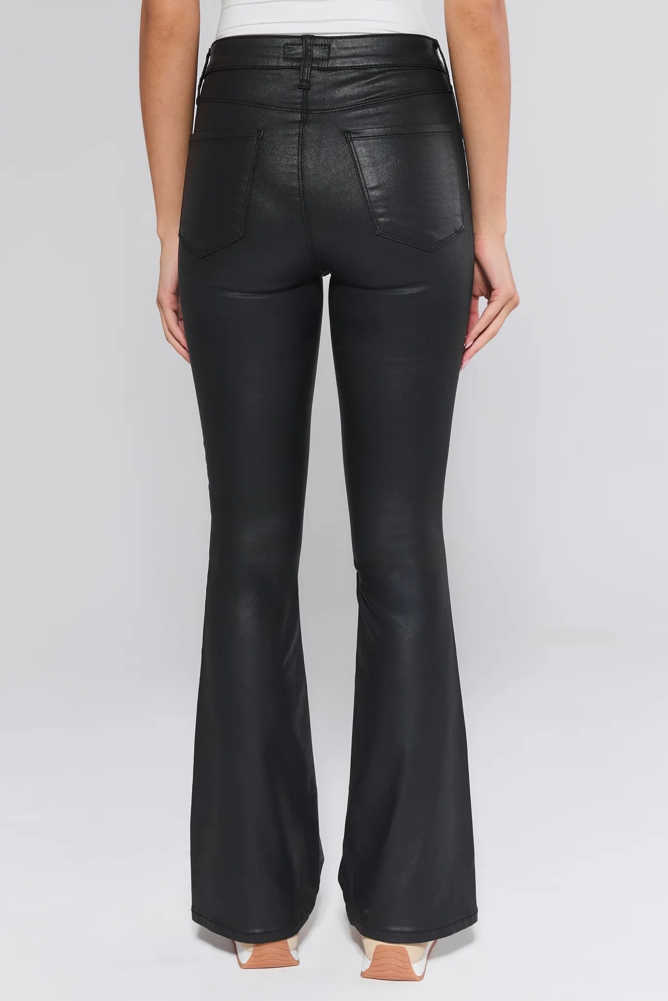 Black Ana Jeans Wax Coated worn by a person on a white background