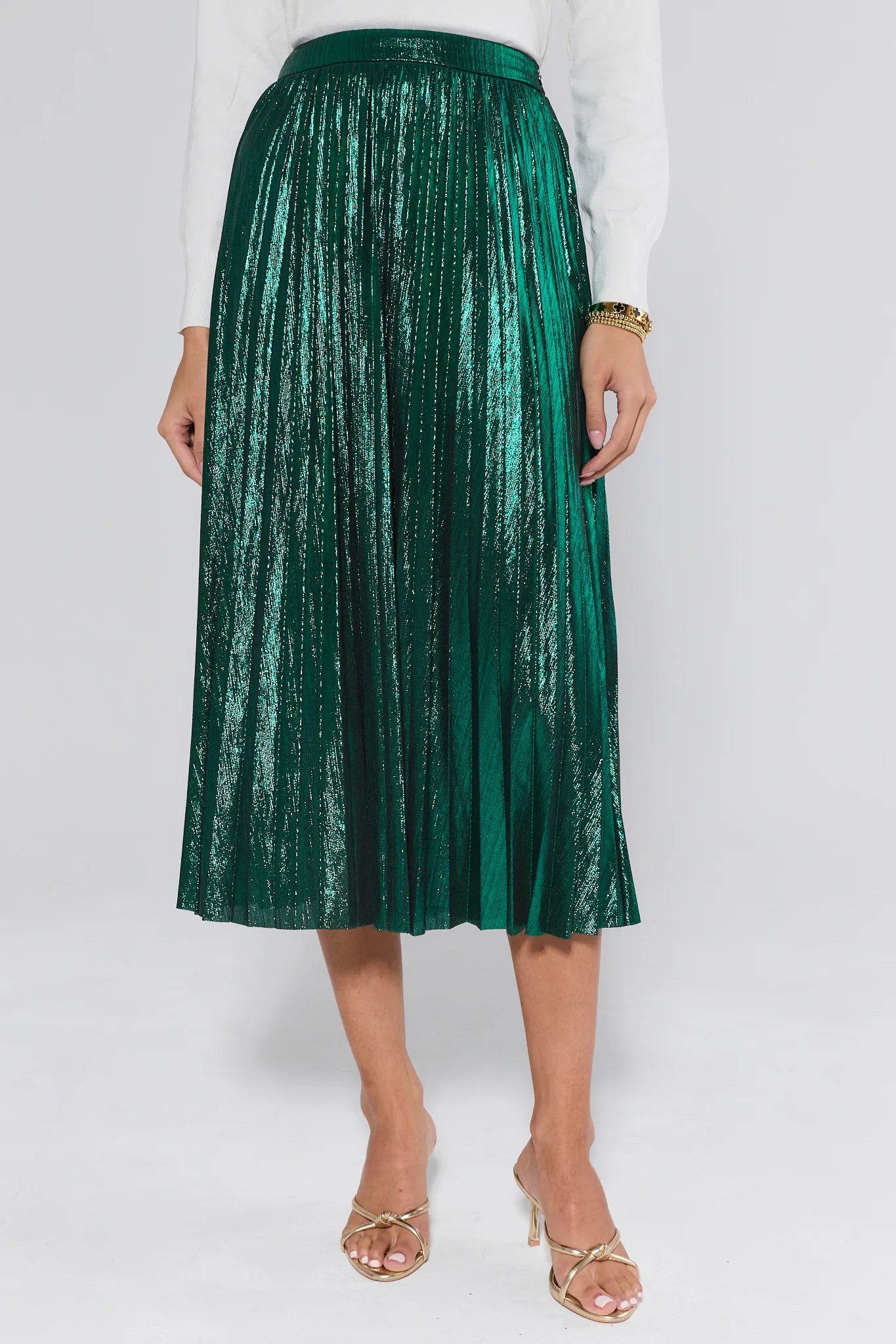 Person wearing a green metallic skirt on a white background