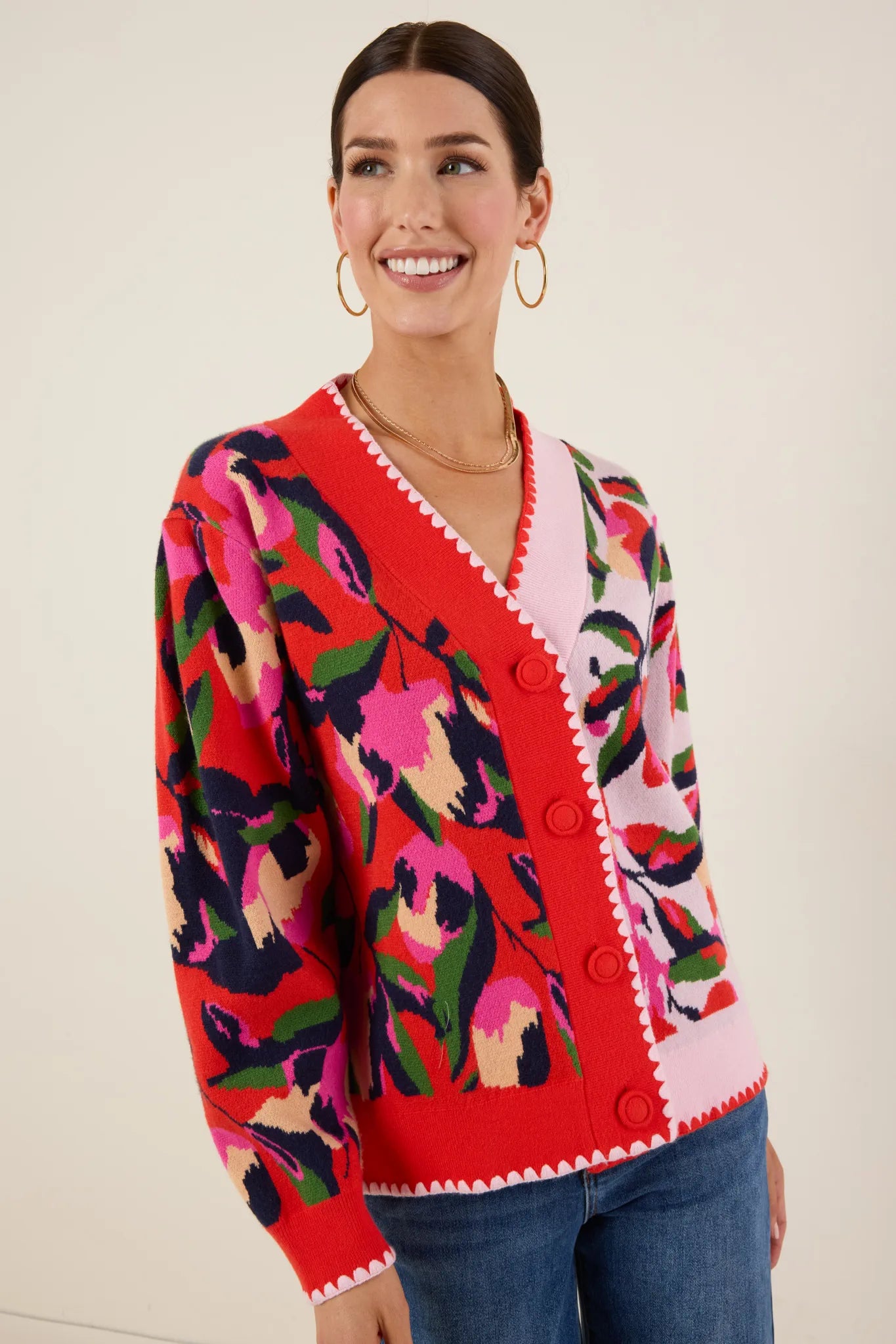 Woman wearing a colorful patterned Leslie Cardigan against a plain background